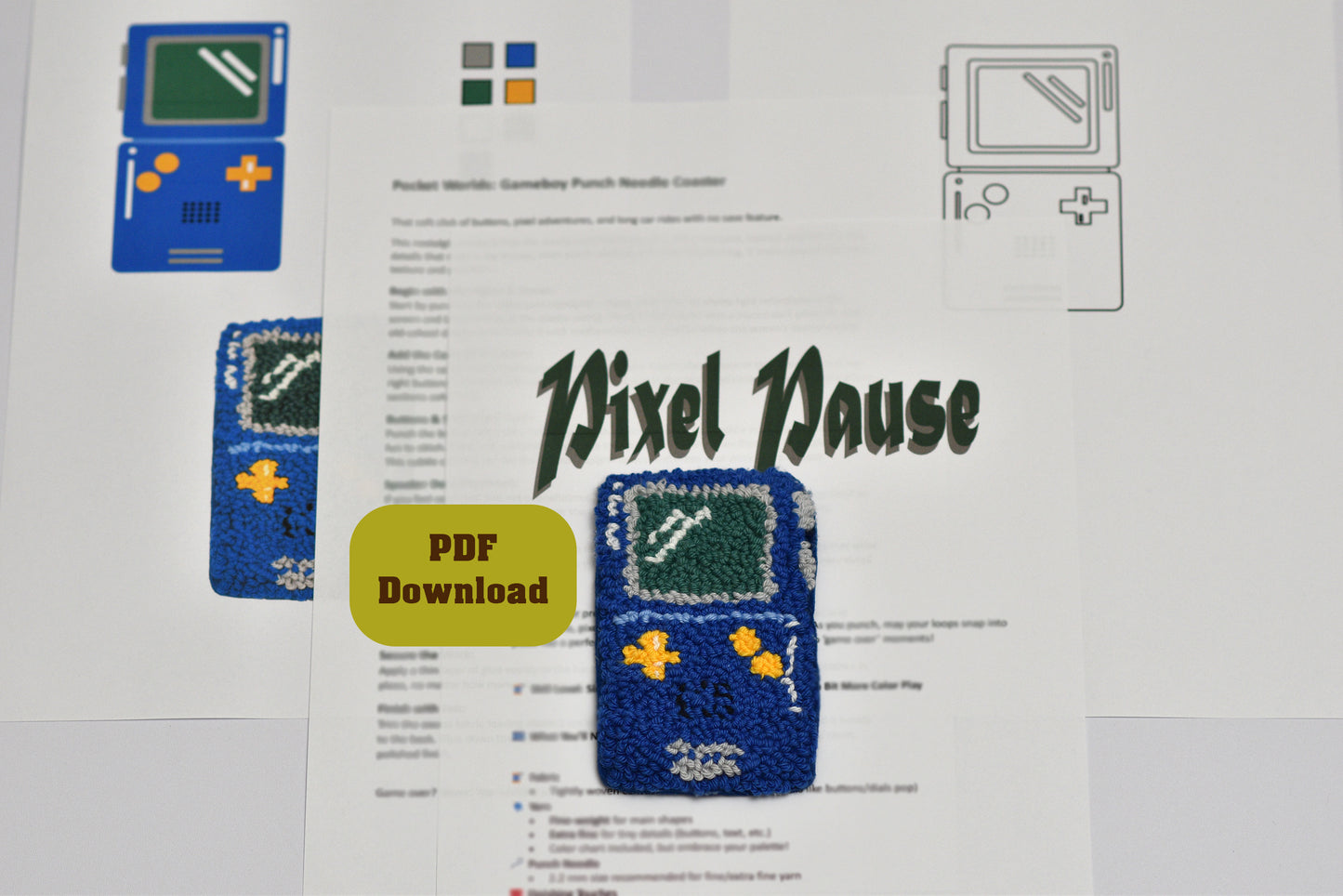 Embroidered pixel art of a game console / Gameboy with 'Pixel Pause' branding on a printed document.