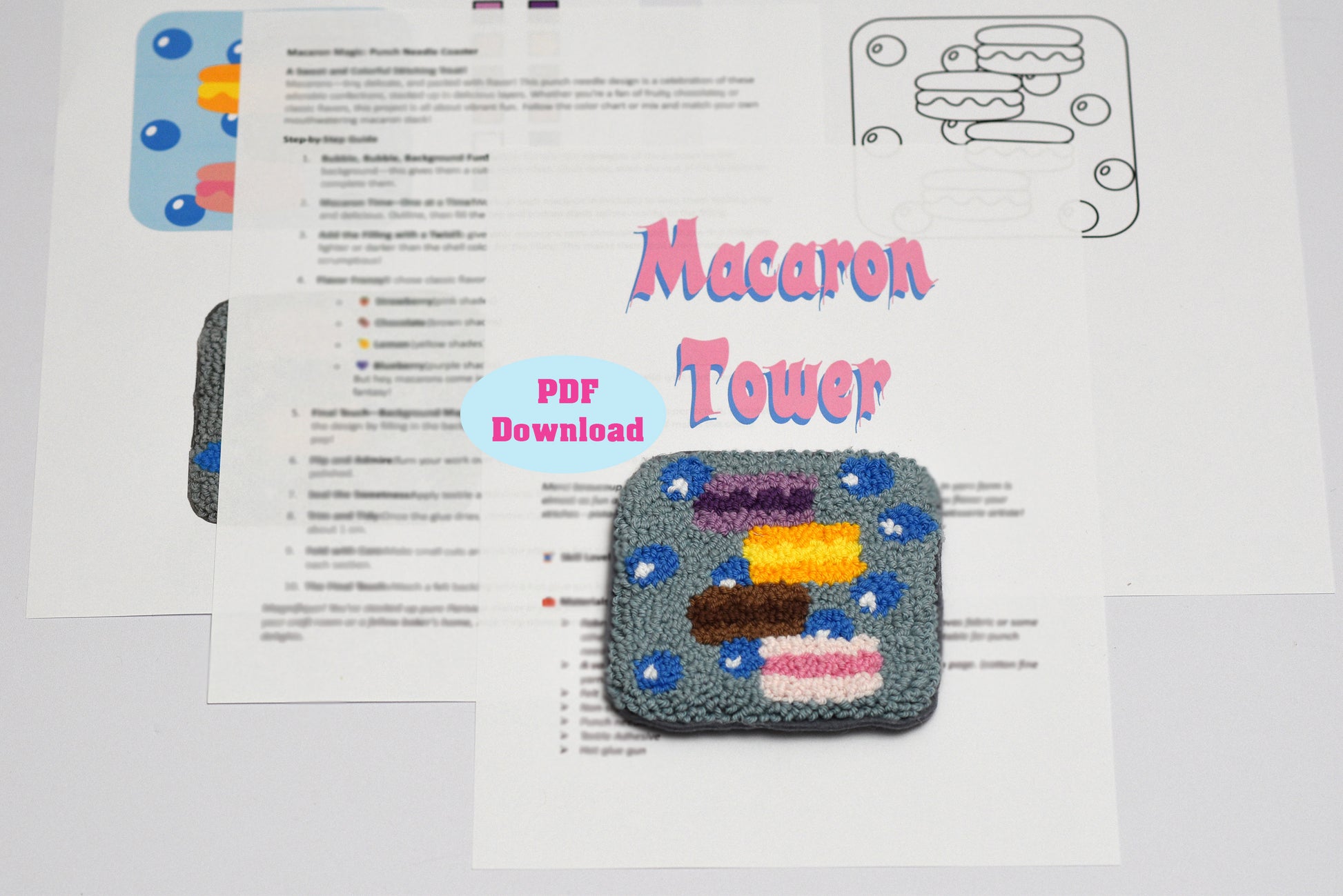 Embroidered coaster design of a macaron tower with a PDF download label on a white background