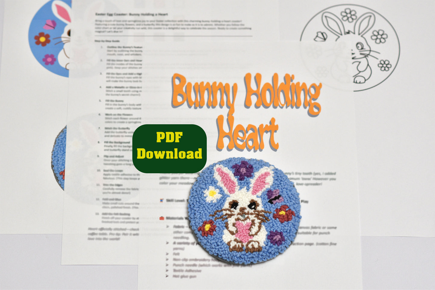 Embroidery design with an Easter bunny holding a heart on a printed pattern sheet.