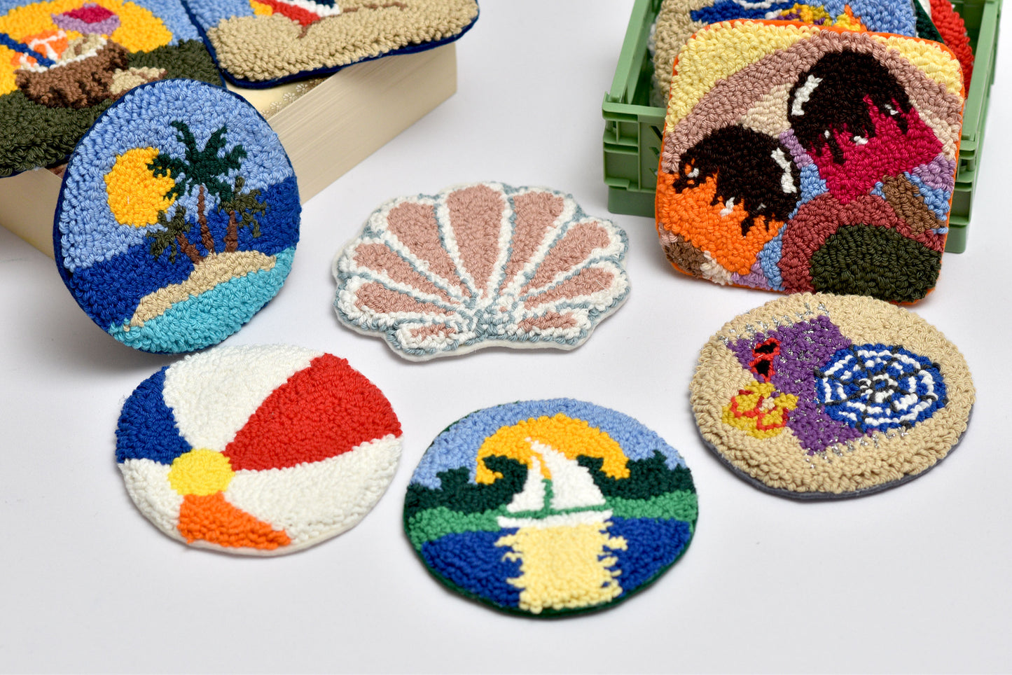 Colorful embroidered coasters with various designs on a white background