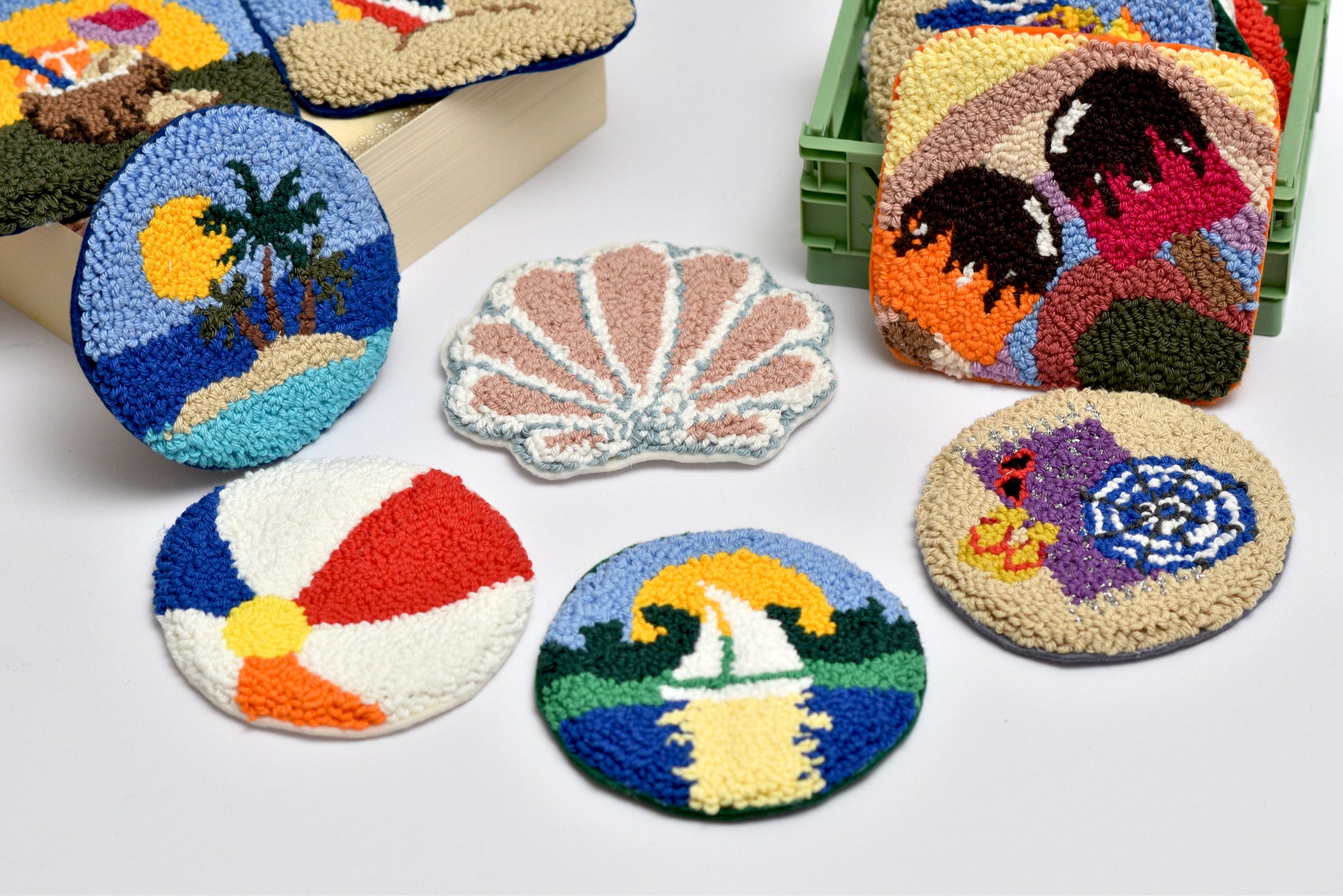 Colorful embroidered coasters with various designs on a white background