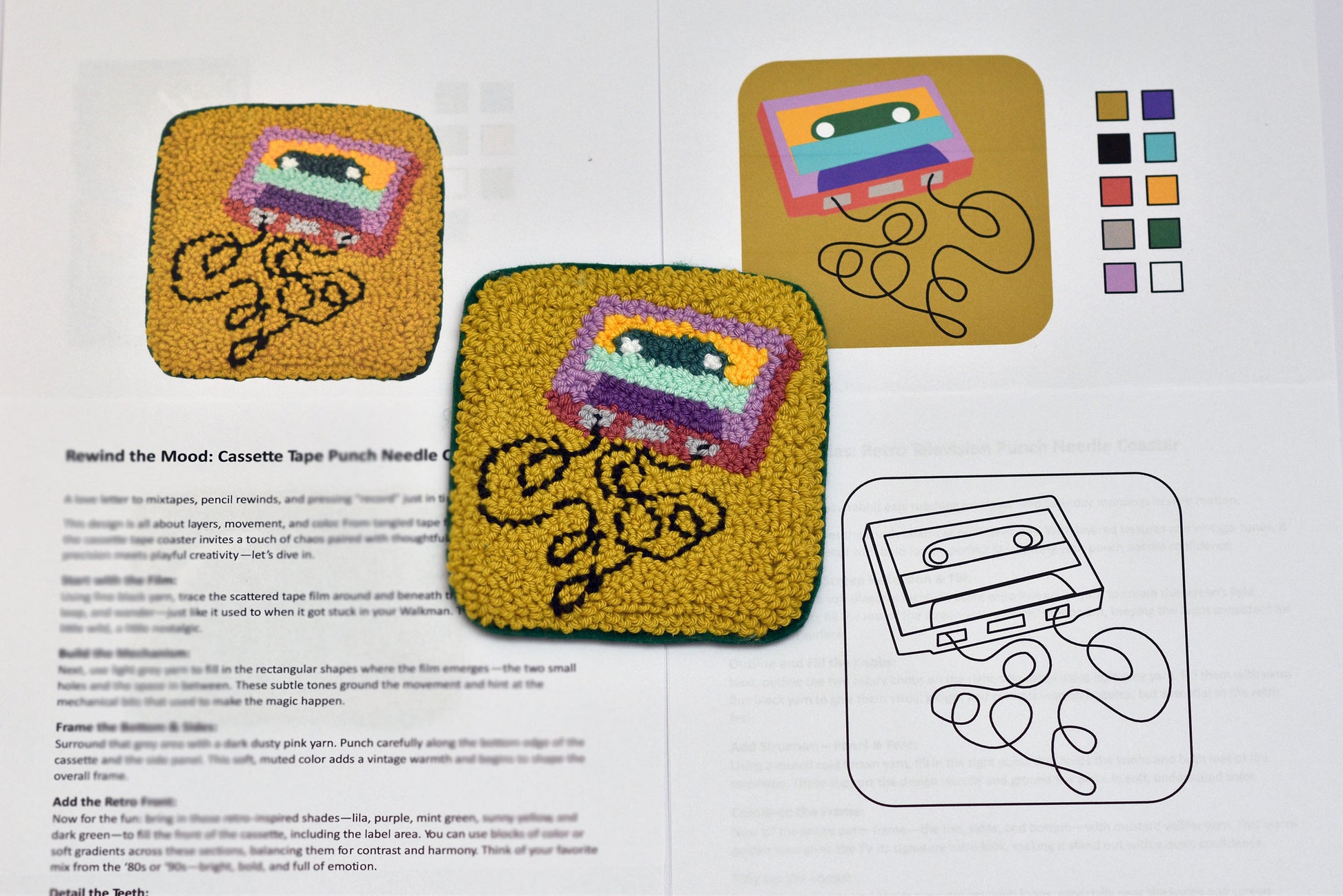 Embroidered coasters of cassette tapes and a needle on a printed pattern sheet.