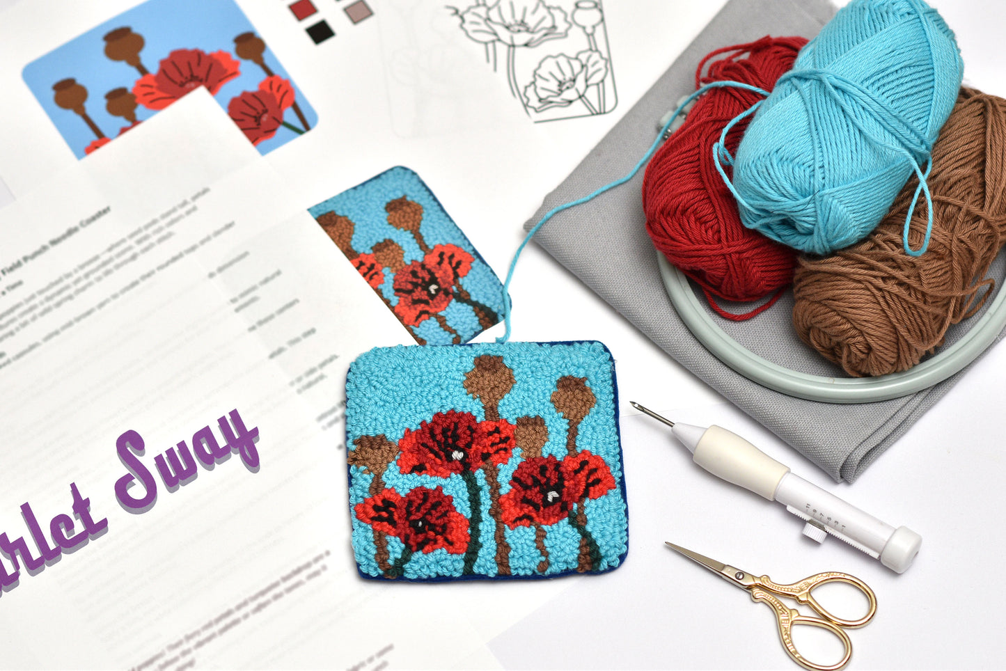 Handmade flower-patterned fabric square coaster with yarn and tools on a table, featuring 'Scarlet Sway' branding.