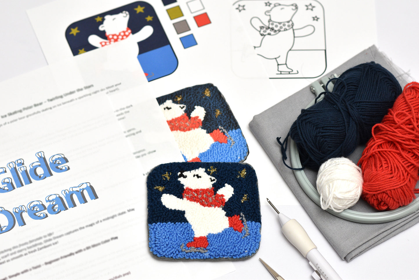 Polar bear punch needle coasters with yarn and needles on a table