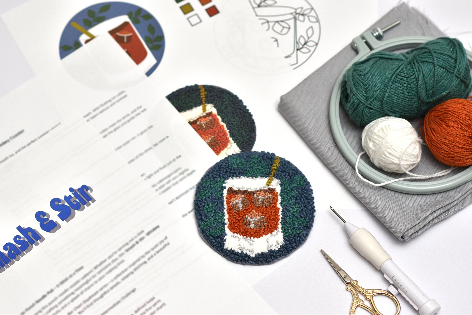 Punch needle Coaster with Whiskey design and Embroidery kit with yarn, scissors, and pattern sheet on a white background