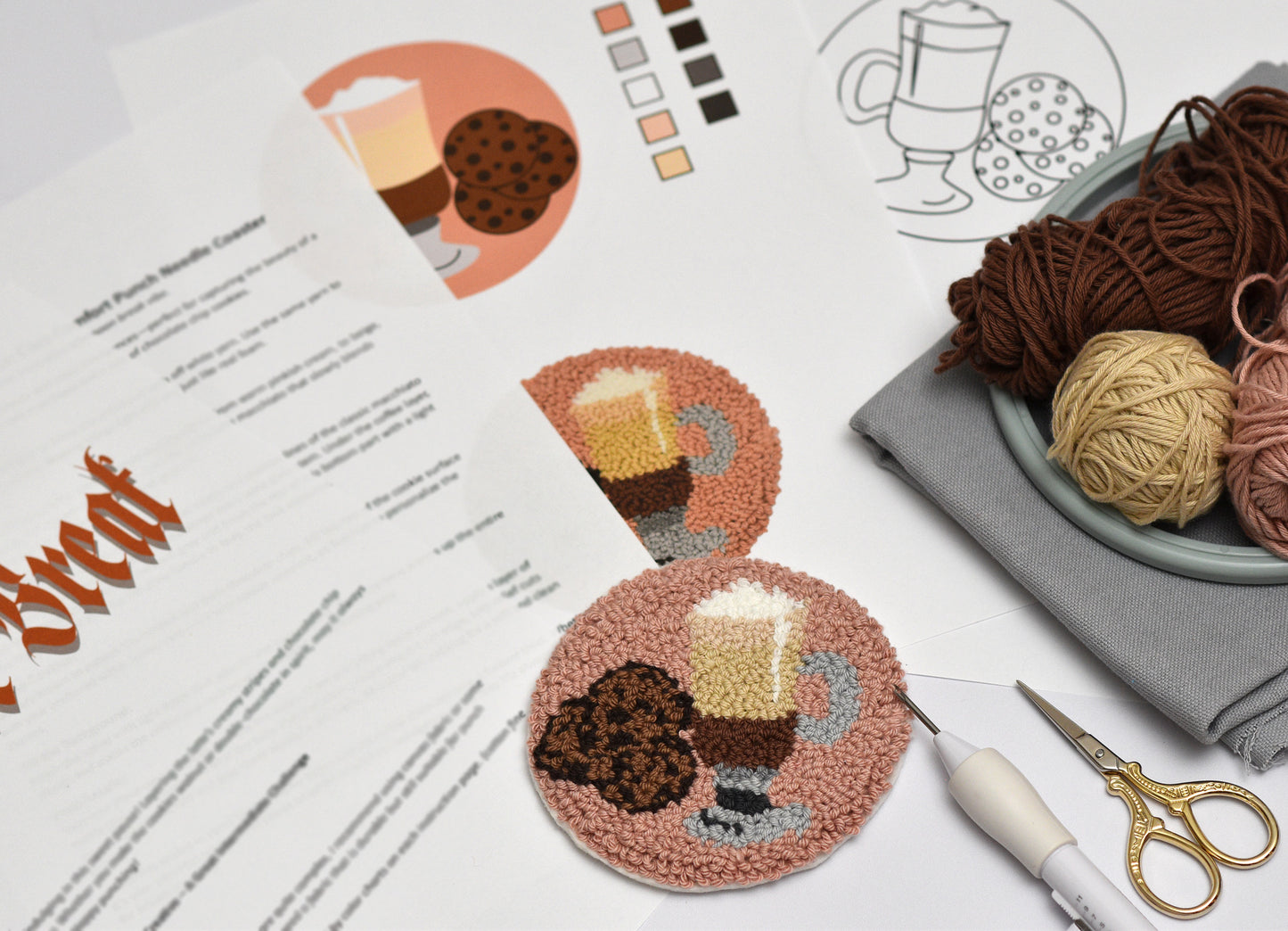 Embroidery coaster project with coasters featuring Coffee Latte and cookies designs, surrounded by yarn and sewing tools.