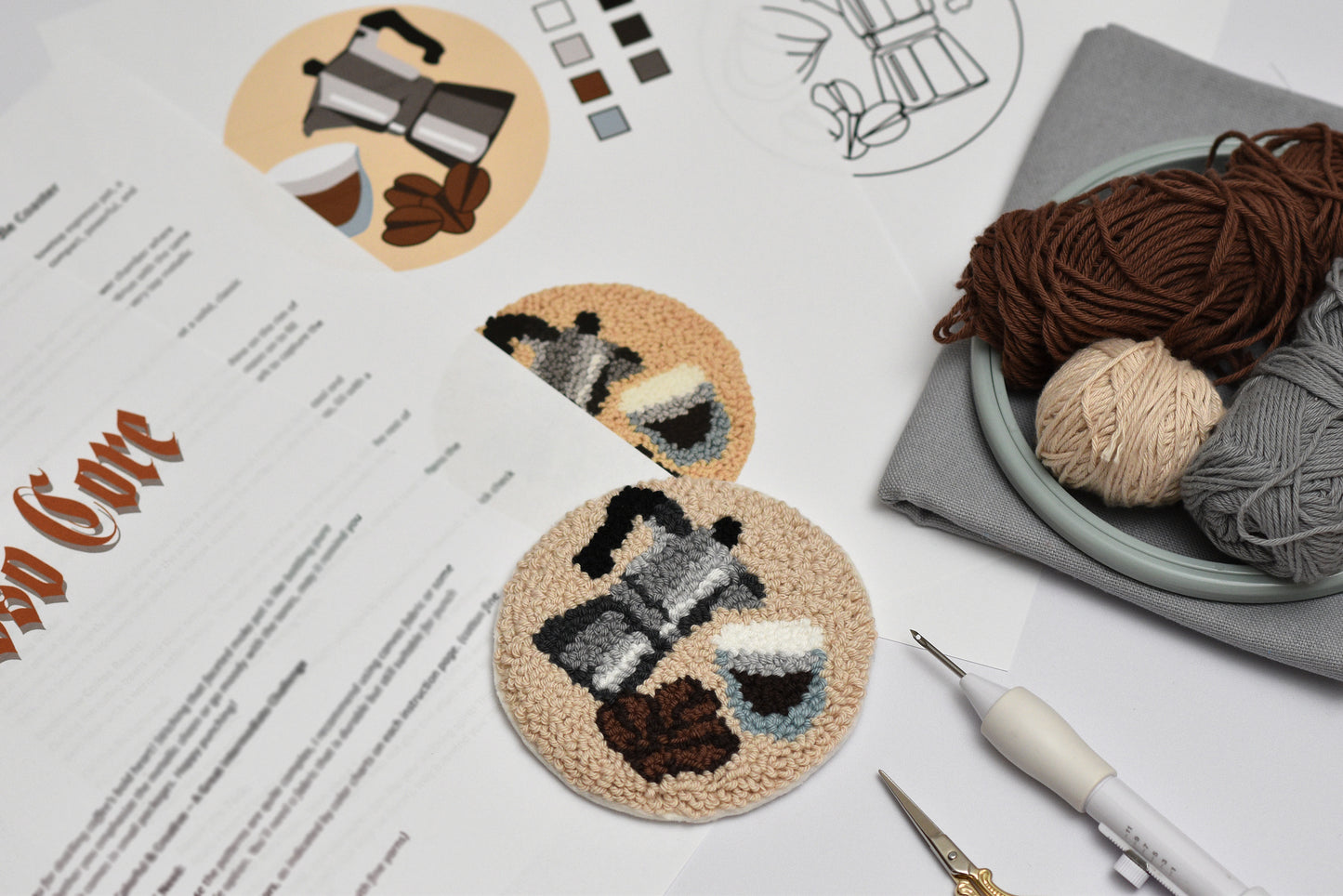Embroidered coaster with espresso coffee design on a table with yarn and tools
