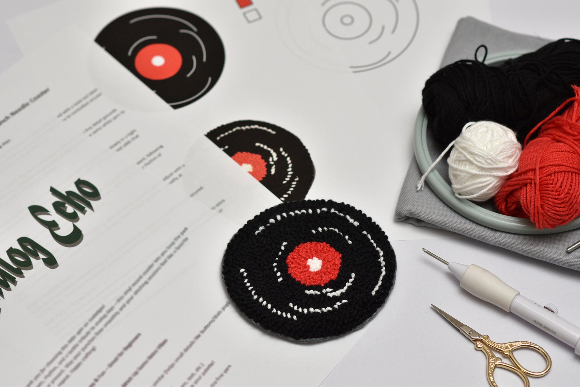 Embroidered Vinyl record coasters on a table with yarn and sewing tools