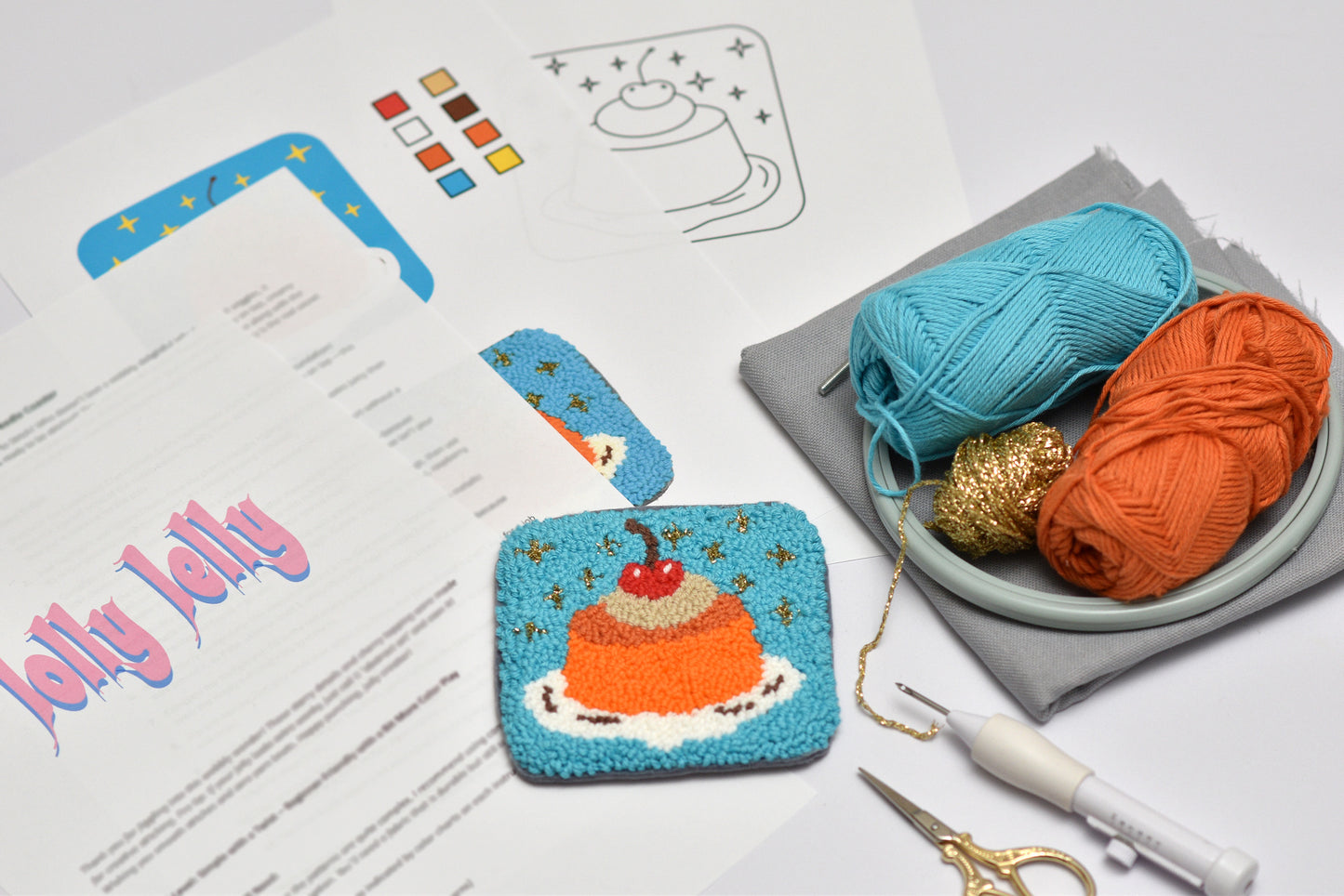 Embroidered coaster project with yarn, scissors, and pattern sheet on a white surface