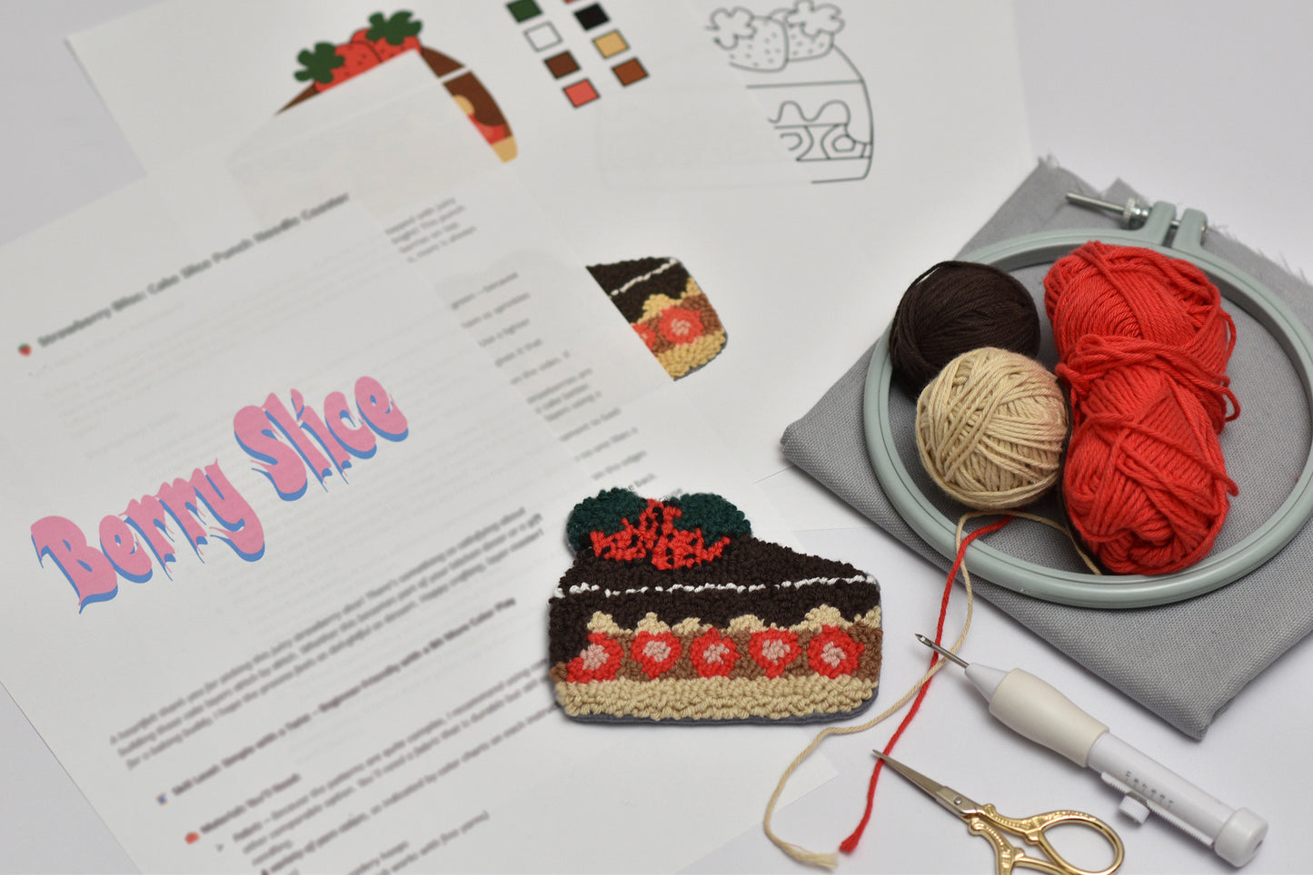 Embroidery hoop with yarn and embroidery kit on a table