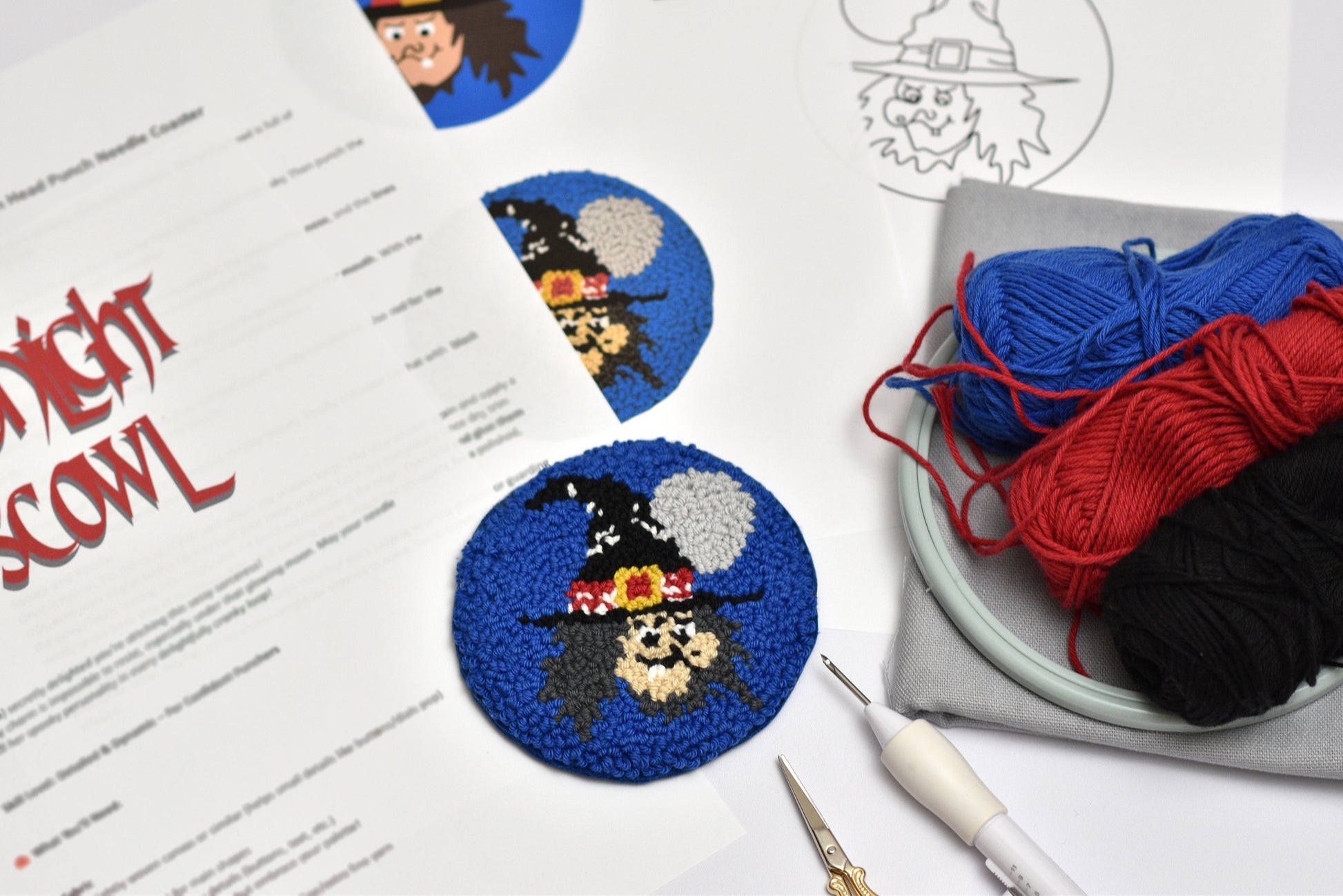 Halloween-themed punch needle  project with yarn and tools on a table