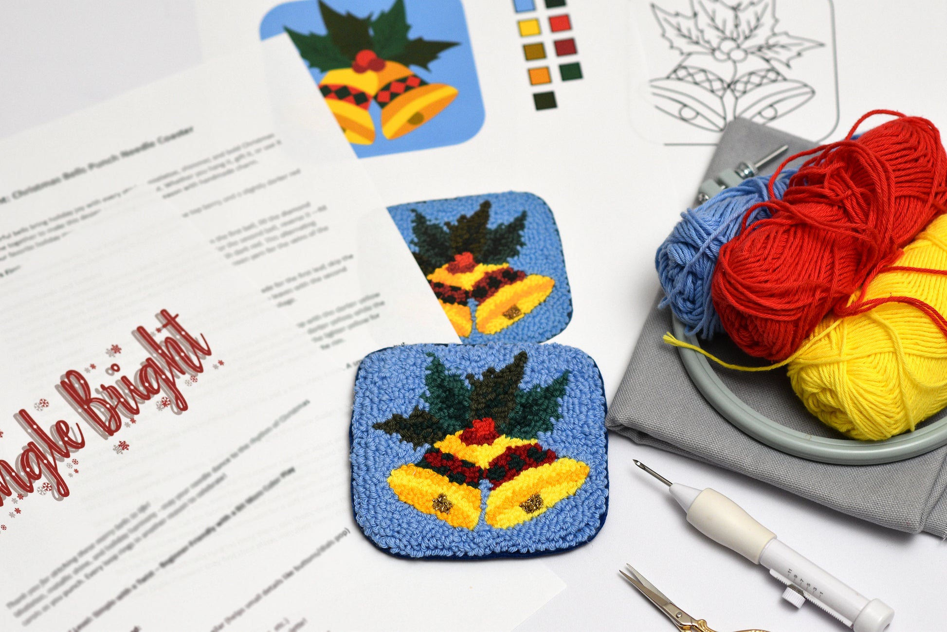 Colorful punch needled coasters with Christmas Bells design on a table with yarn and tools.
