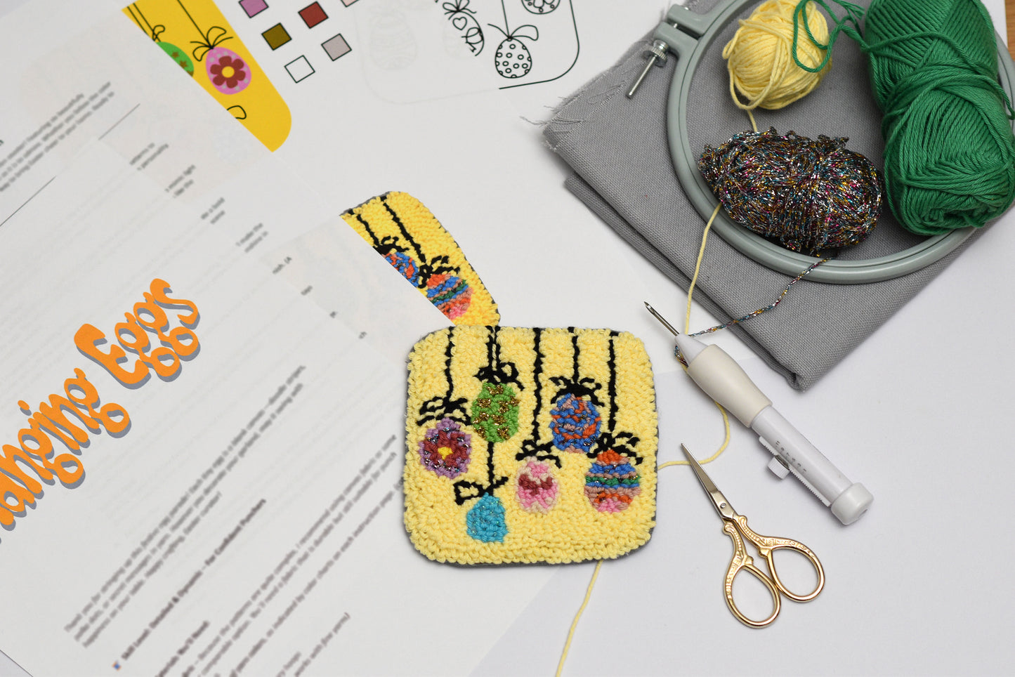 Handmade embroidered Easter Egg coaster on a table with yarn and tools