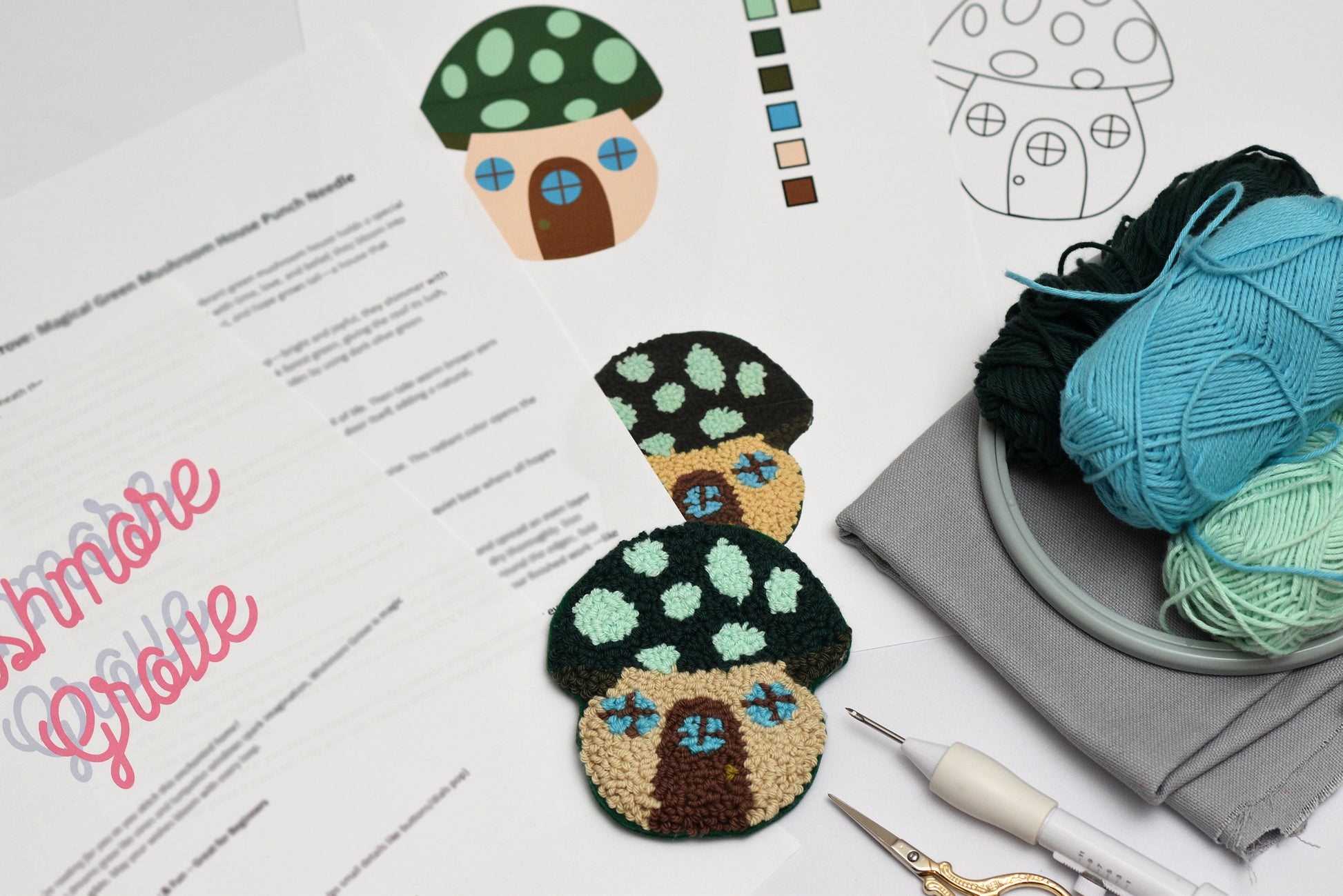 Embroidered mushroom house coasters on a piece of paper with text and yarn.