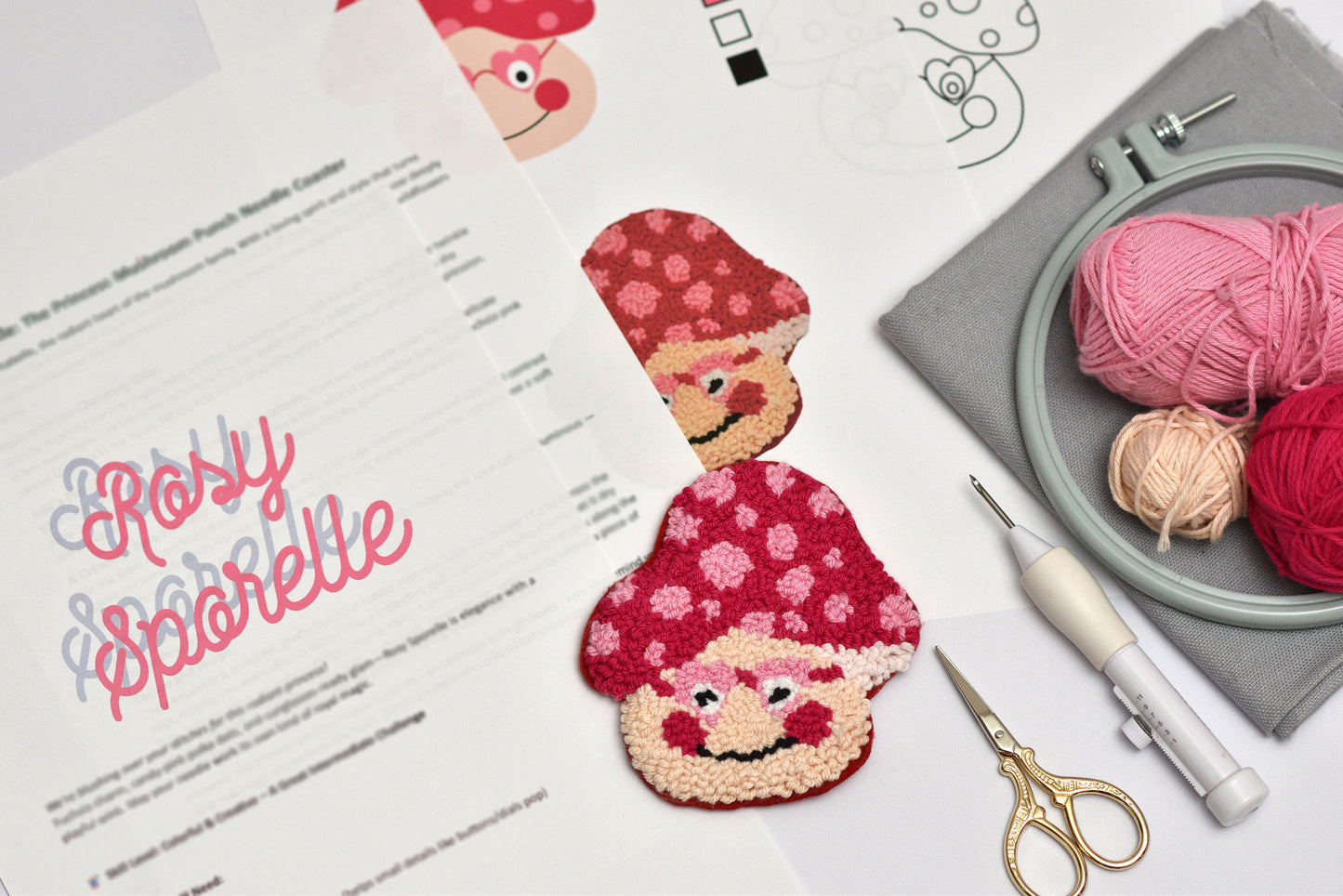 Embroidery coaster project with mushroom-themed coasters, yarn, and sewing tools on a table.