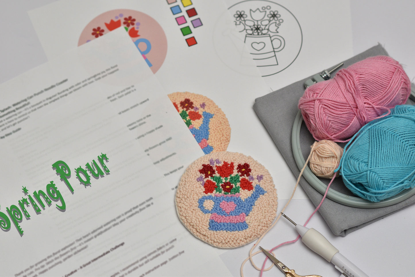 Crafting materials including yarn and coasters with floral designs on a table.
