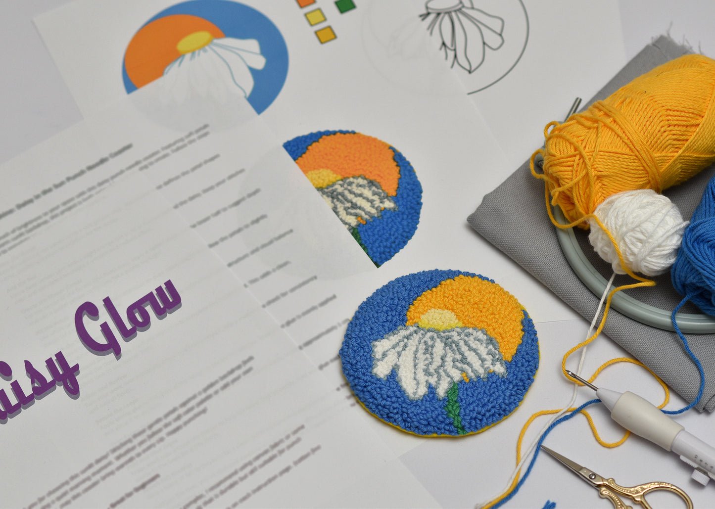 Embroidered coaster with floral designs on a paper with 'Daisy Glow' branding.