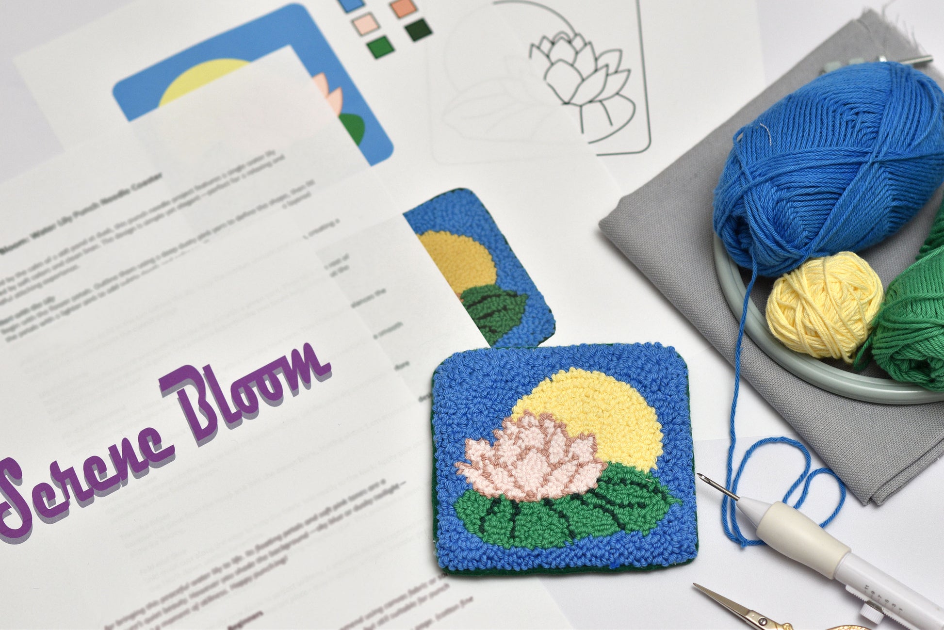 Punch needled lily flower coaster with yarn and knitting tools on a table