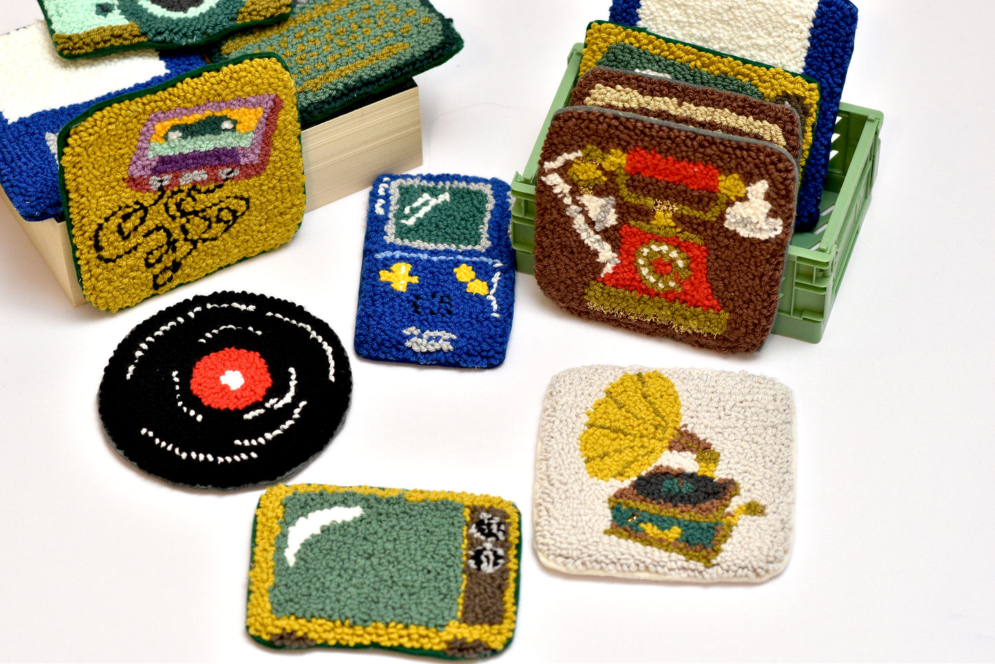 Collection of colorful coasters with various vintage device designs on a white background