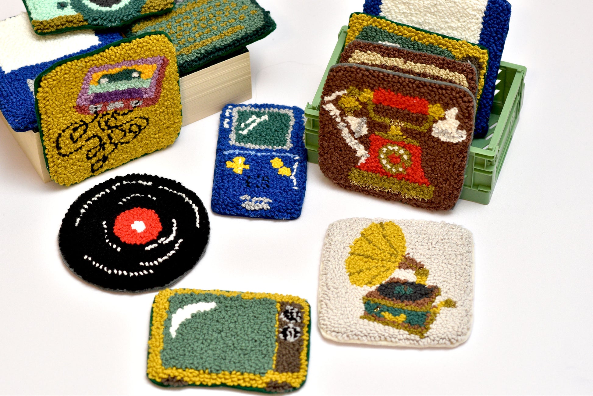 Collection of colorful coasters with various vintage device designs on a white background