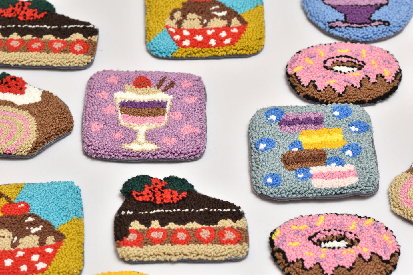 Collection of colorful embroidered patches featuring various desserts on a white background.