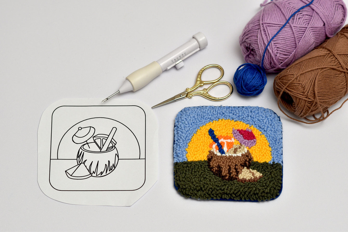 Finished examples of colorful summer punch needle coasters made using patterns from digital guide