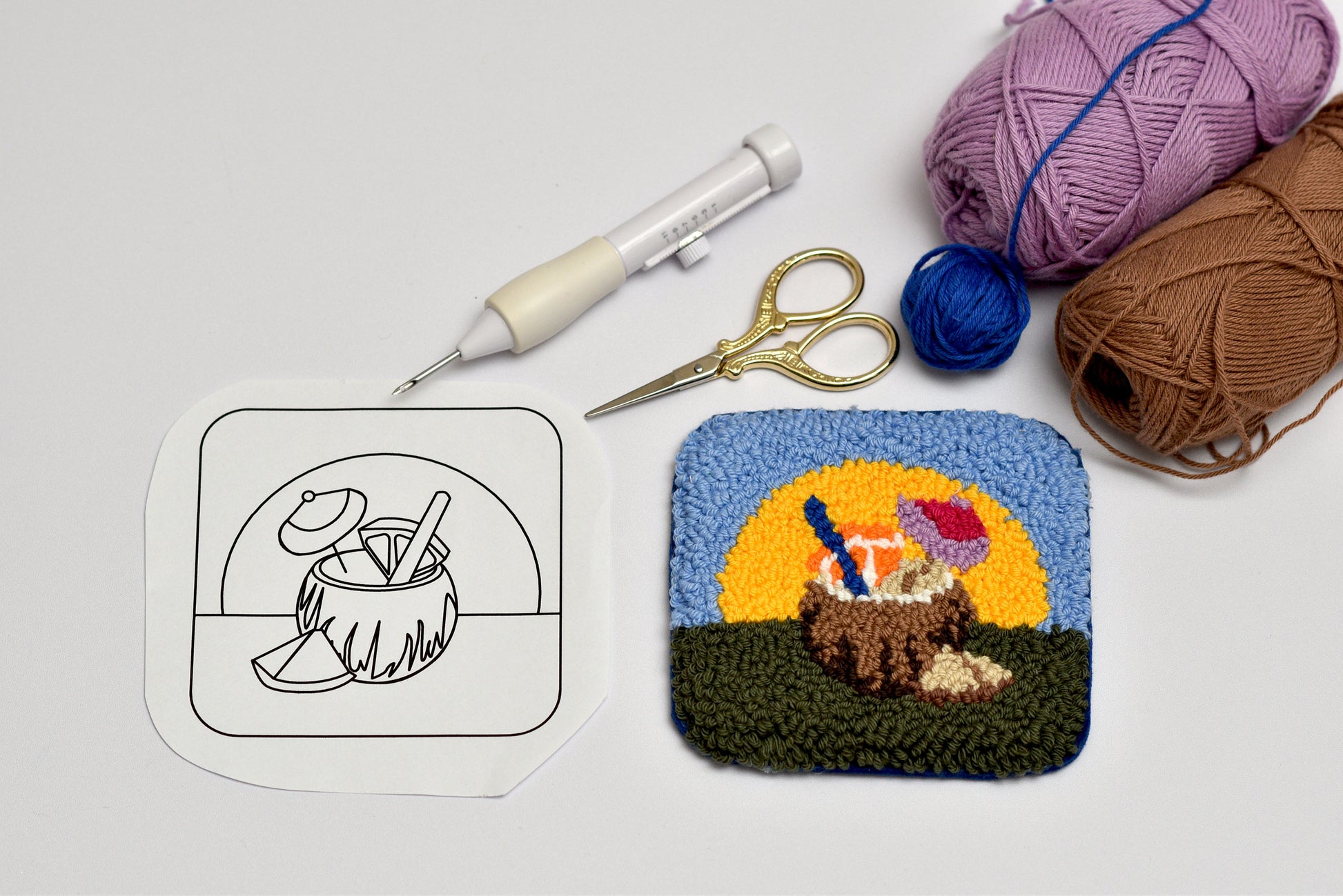 Finished examples of colorful summer punch needle coasters made using patterns from digital guide