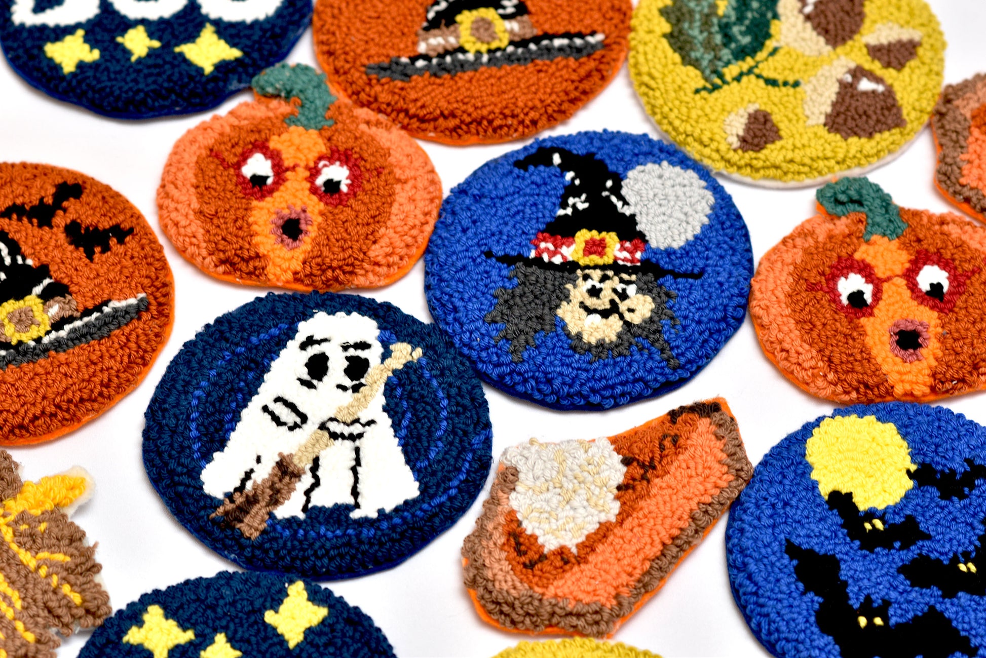 Collection of Halloween-themed embroidered coasters on a white background