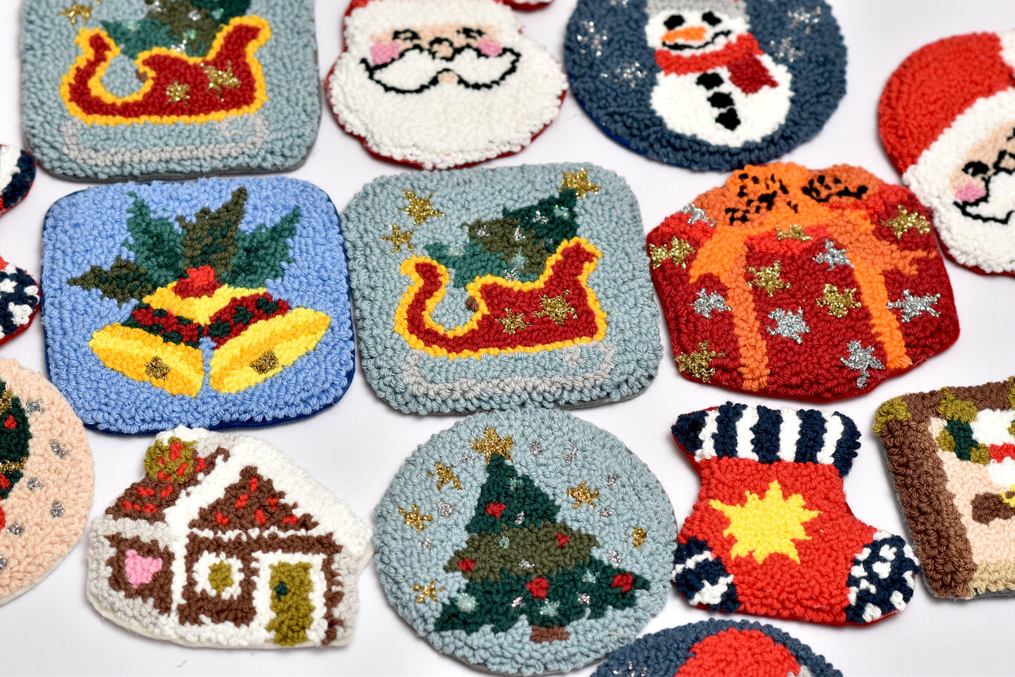 Collection of Christmas-themed punch needled coasters on a white background