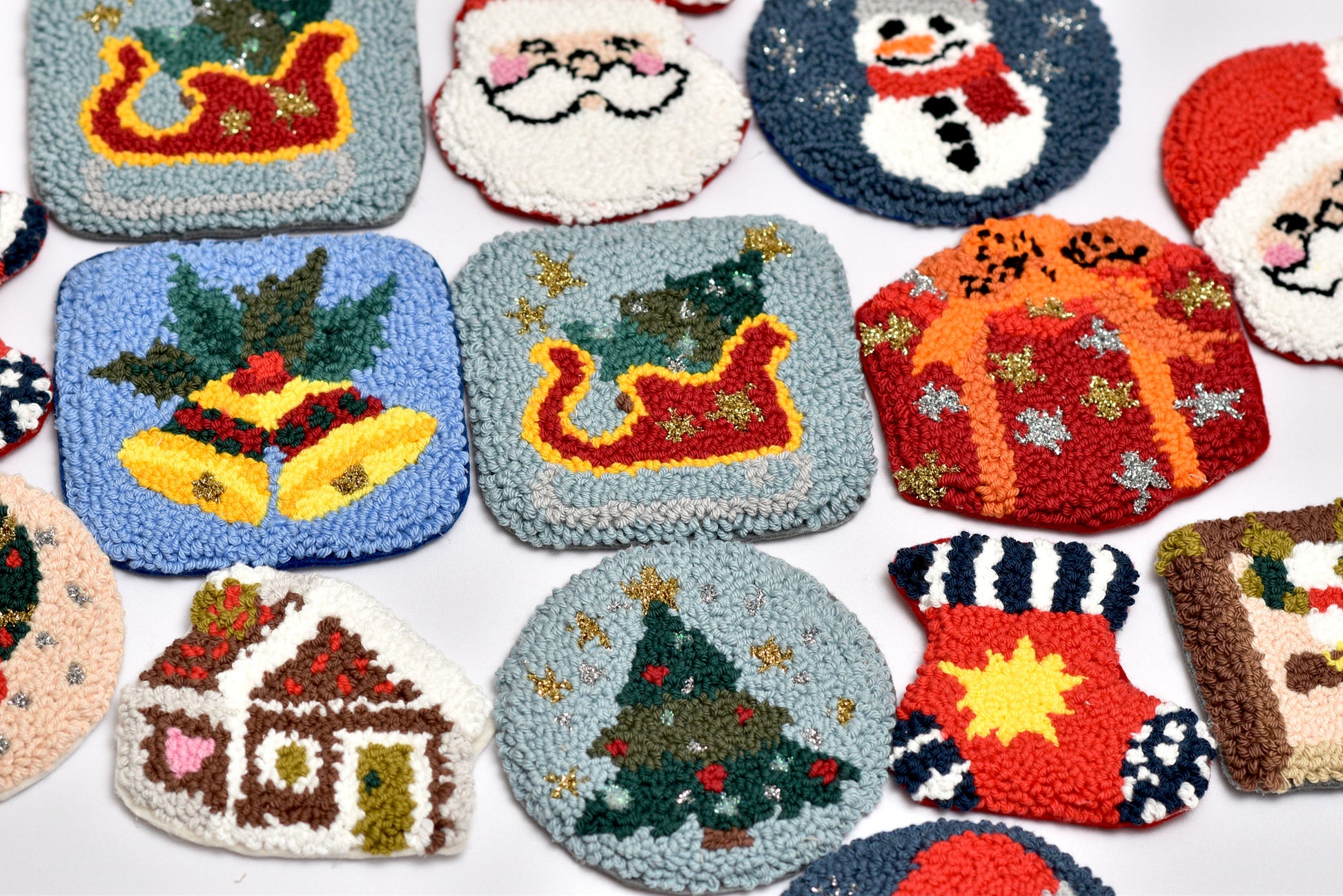 Collection of Christmas-themed punch needled coasters on a white background