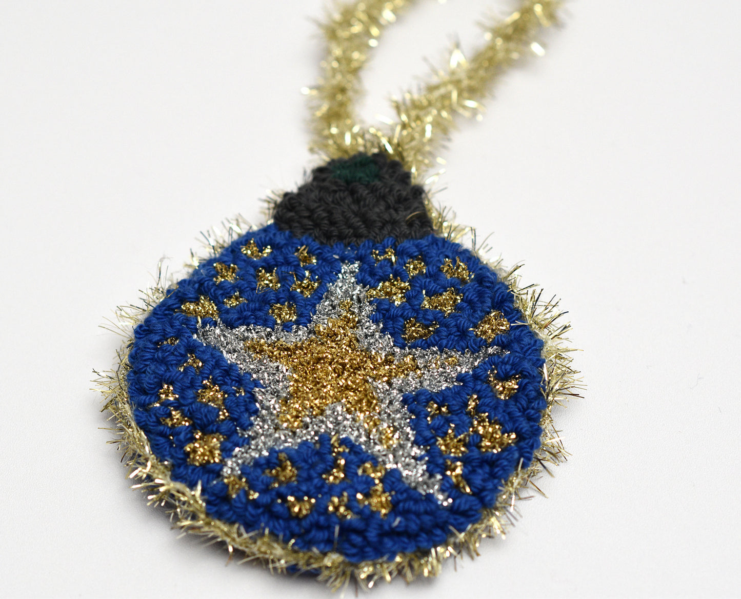 Decorative ornament star designed with blue, gold, and black colors on a white background