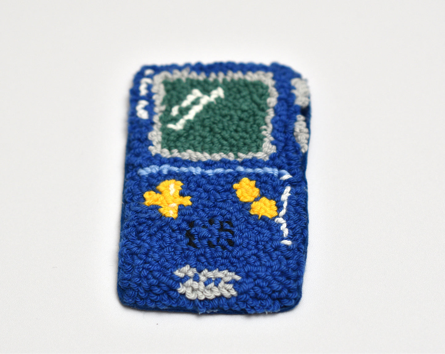 Blue Game Boy designed coaster with a green screen on a white background