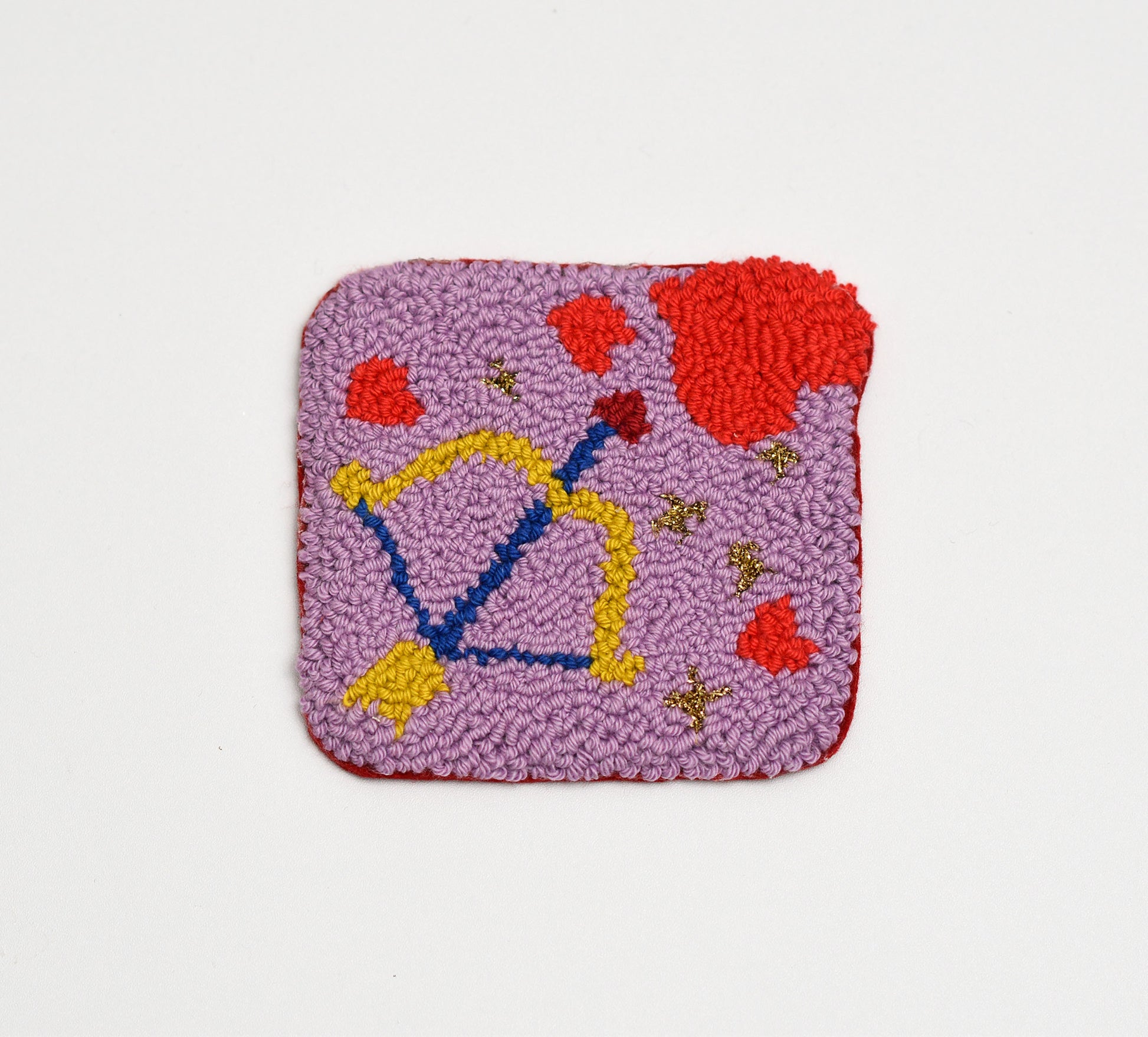 Square textured coaster with colorful cupids bow and hearts design on a light gray background