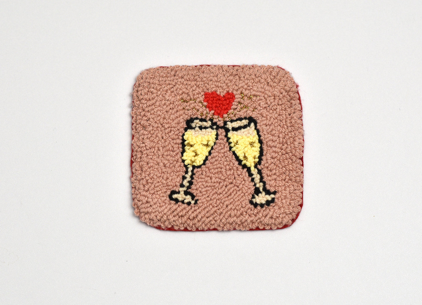 Square patch with two champagne glasses and a heart on a pink background