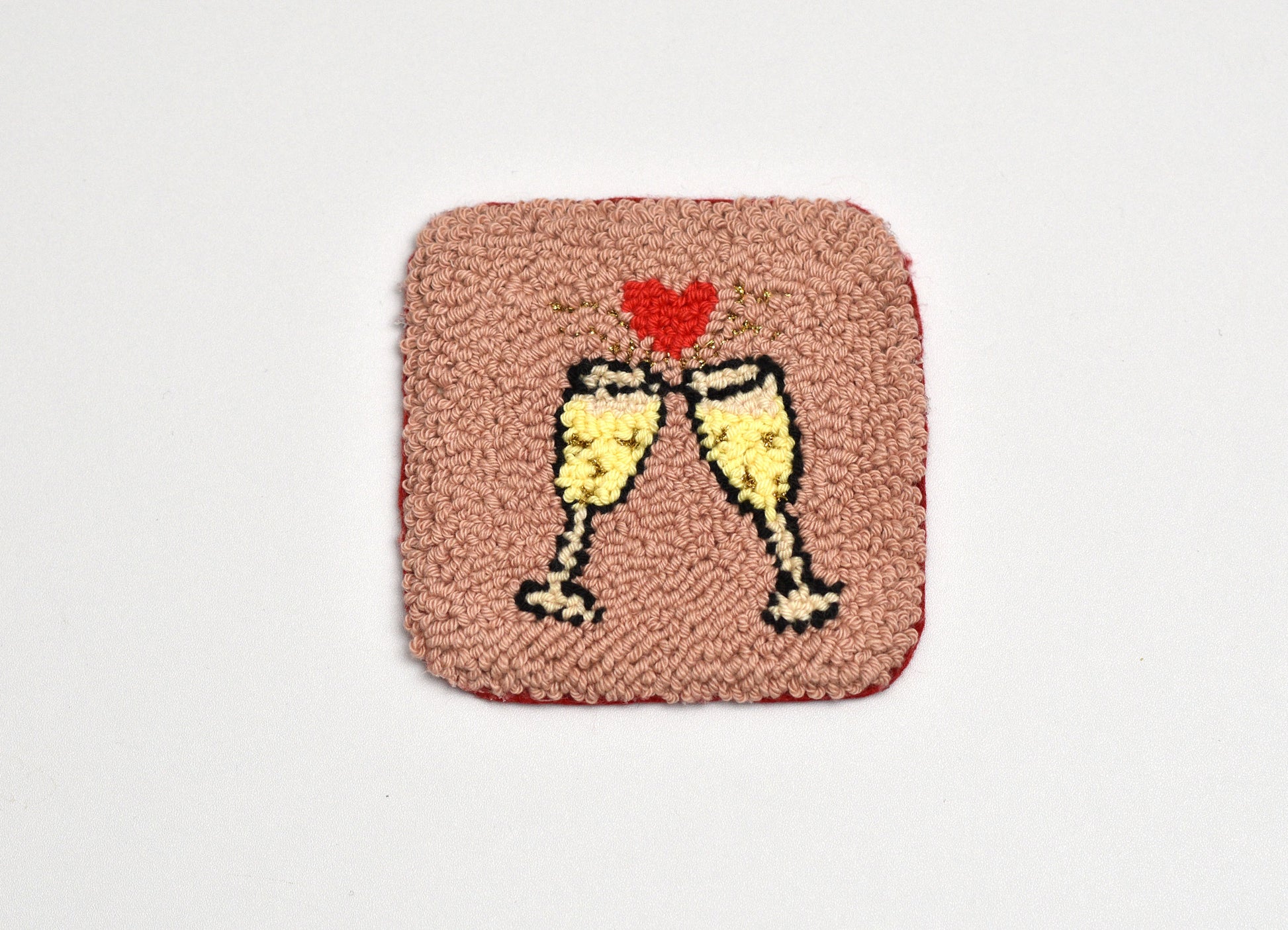Square patch with two champagne glasses and a heart on a pink background