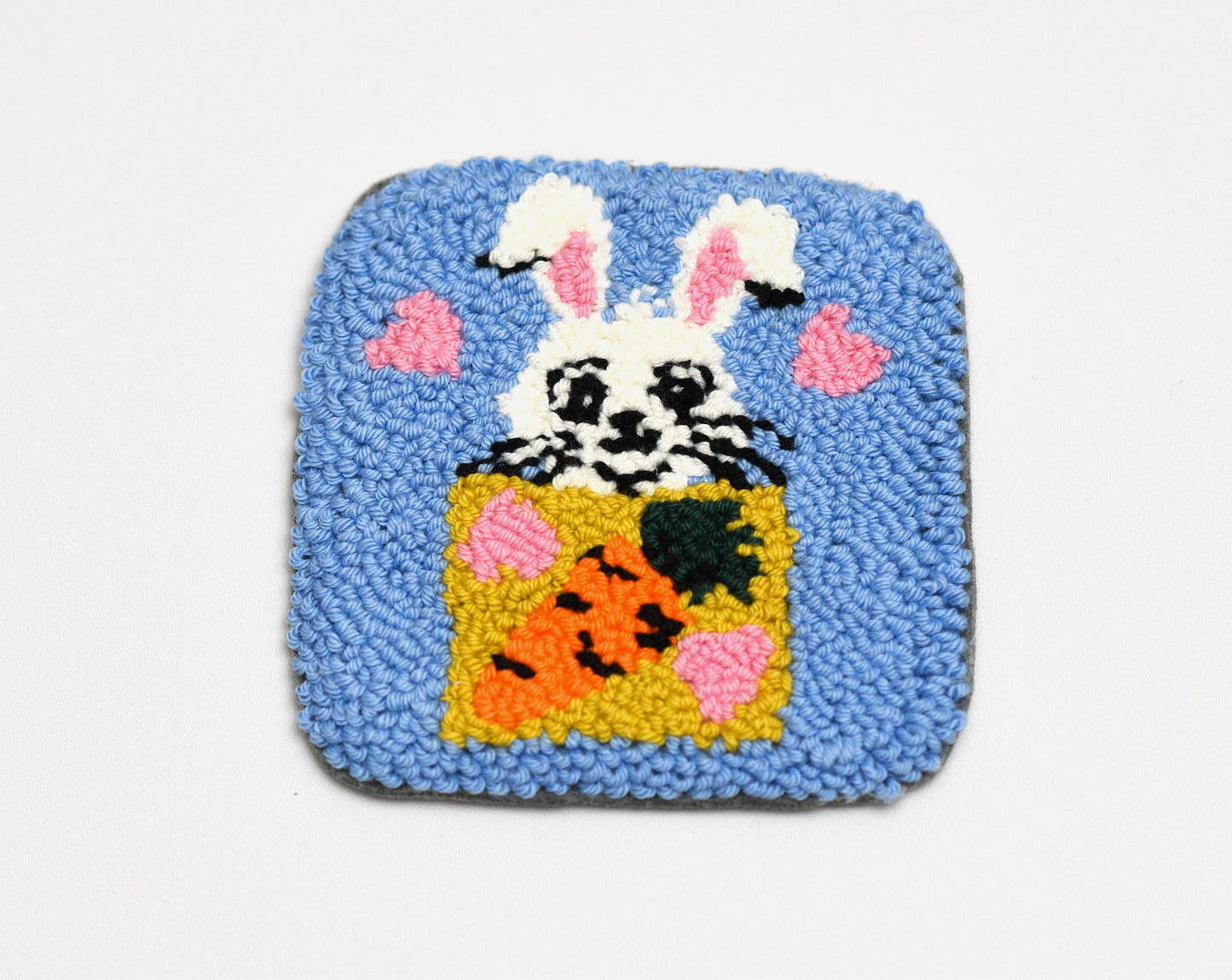 Square rug with a Easter Bunny inside a box on a blue background