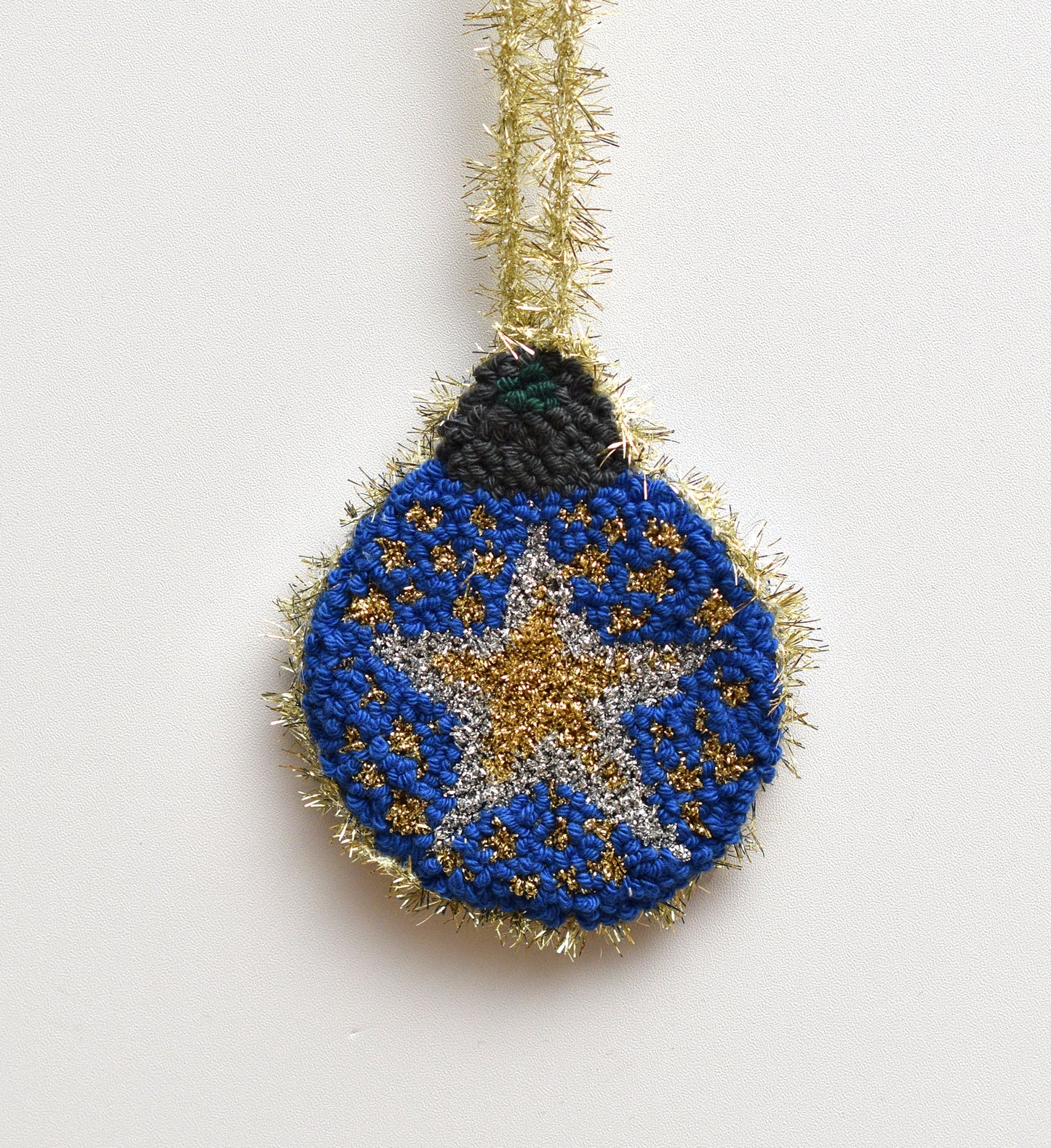Decorative ornament with blue and gold star design on a white background