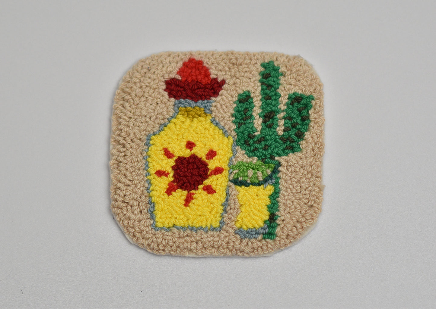 Decorative mug rug with a Tequila bottle and cactus design on a beige background