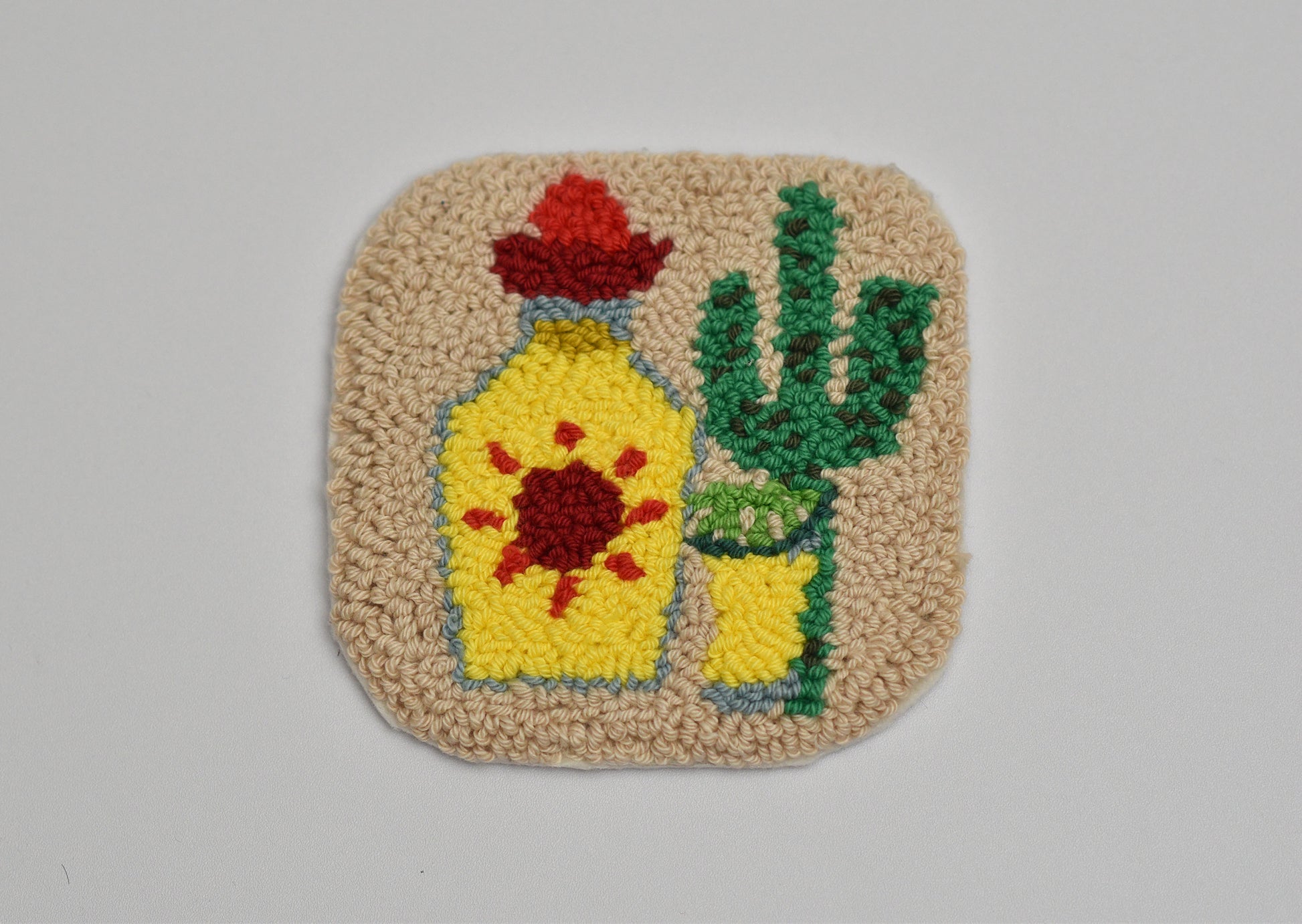 Decorative mug rug with a Tequila bottle and cactus design on a beige background