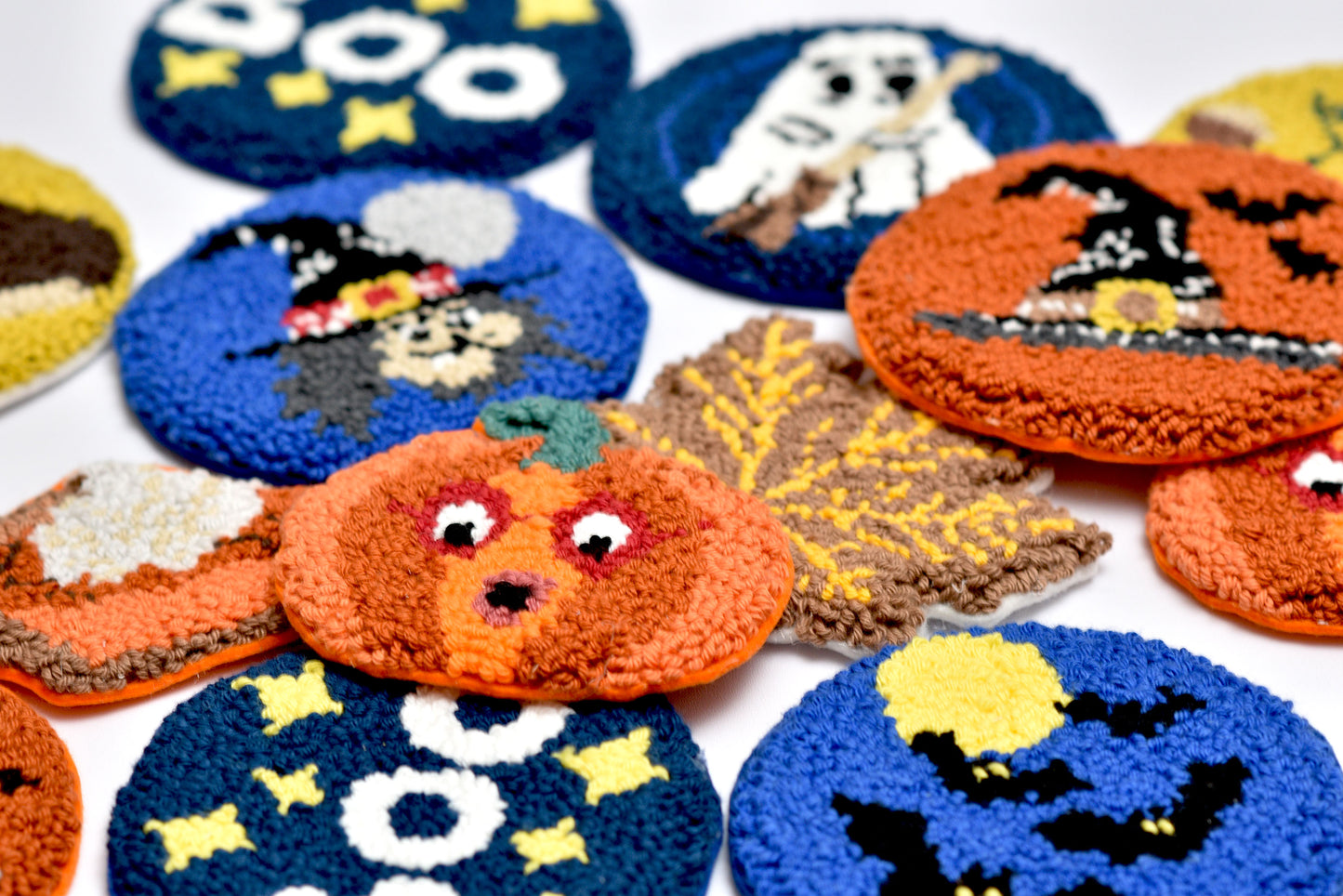 Collection of Halloween-themed punch needled coasters on a white background