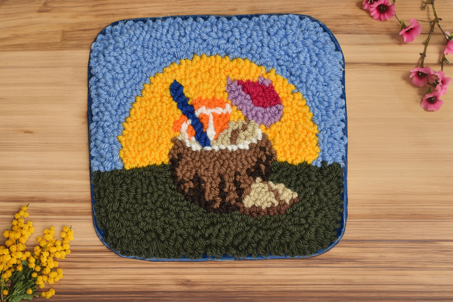 Decorative rug with a coconut design with sun background on a wooden surface.