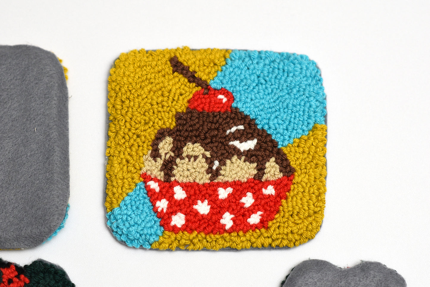 Square woven coaster with a dessert design on a white background