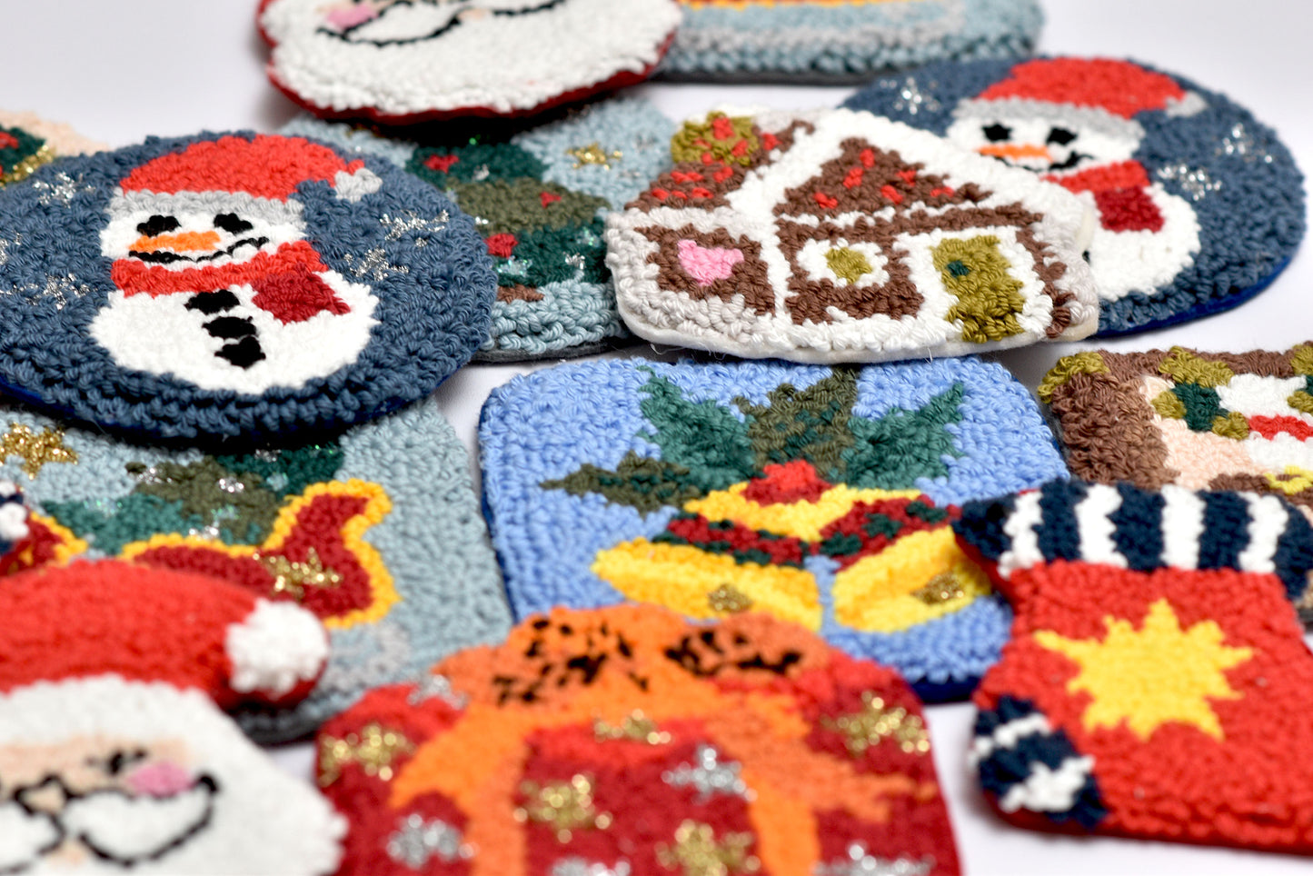 Collection of colorful punch needled coasters with Christmas designs.
