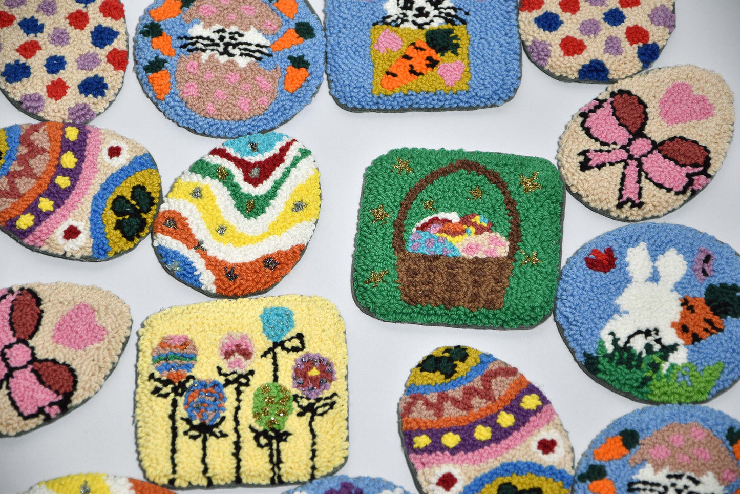 Several Punch needle easter coasters with easter egg and easter bunny designs