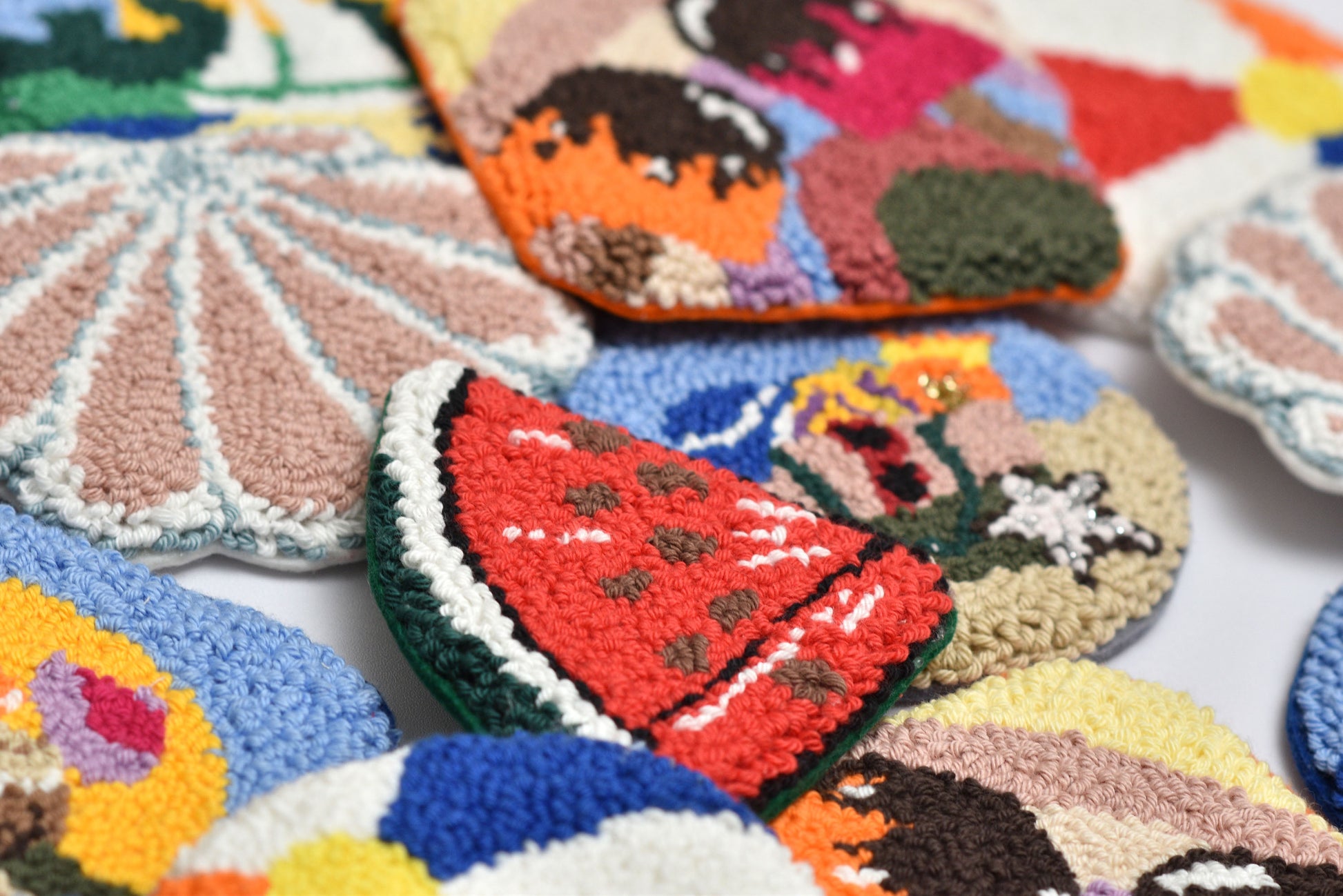 Colorful embroidered patches with various designs on a white background