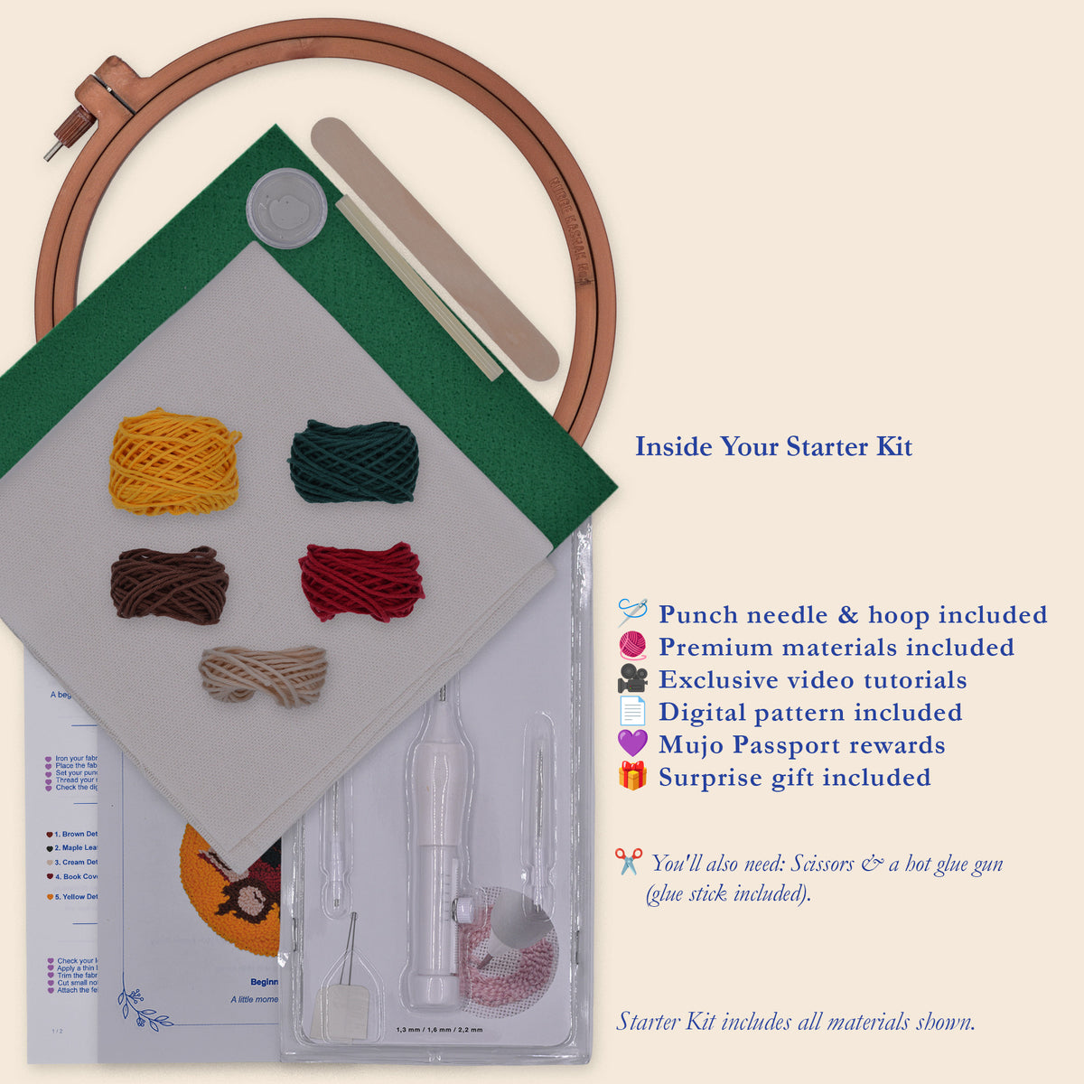 A flat-lay product shot of a punch needle starter kit on a warm cream background. The kit includes a wooden embroidery hoop, a green-and-white fabric sampler, several colored threads, a clear plastic case with punch needle, and printed instruction sheets.