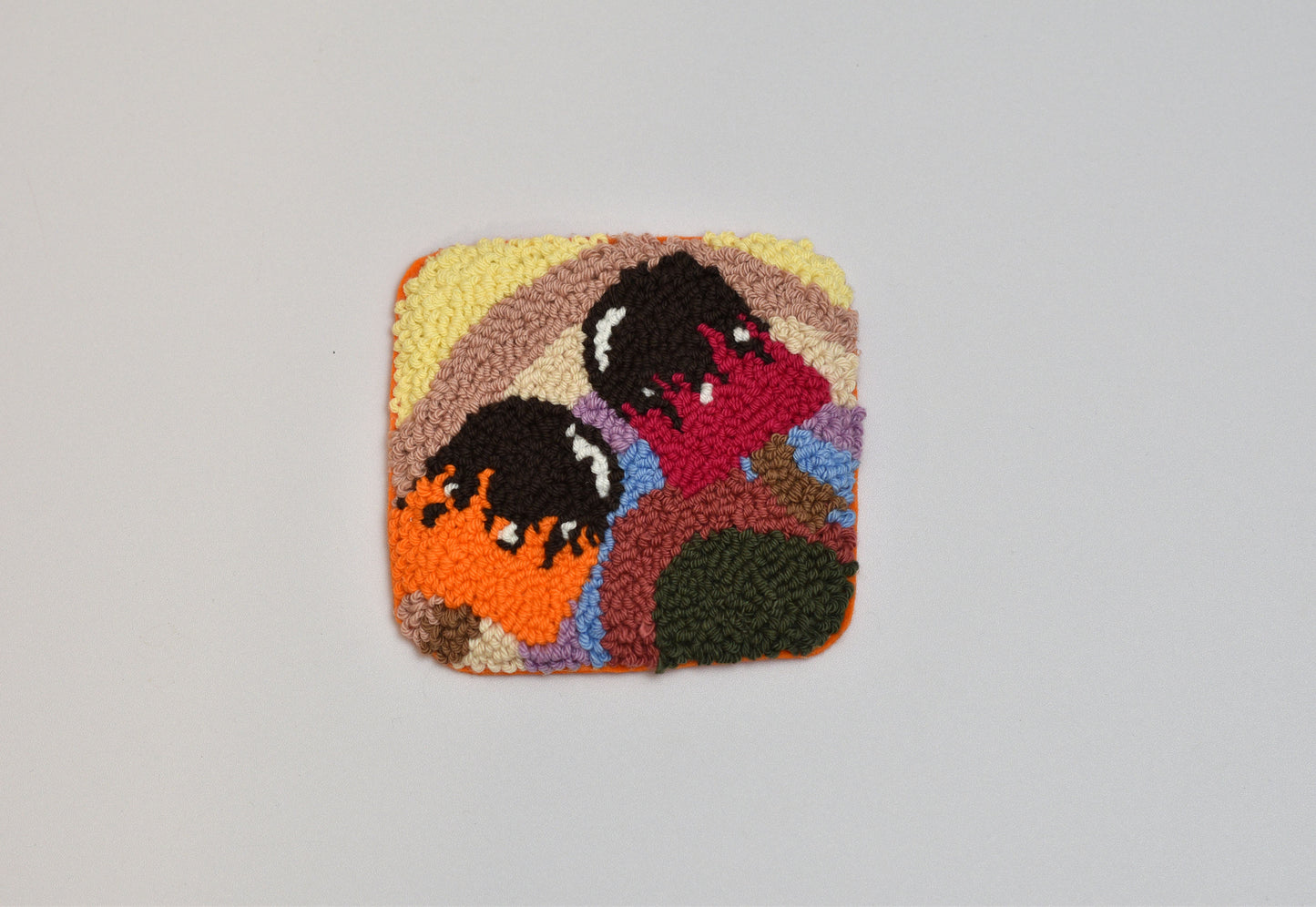 Square patch with embroidered design of two popsicles on a gray background