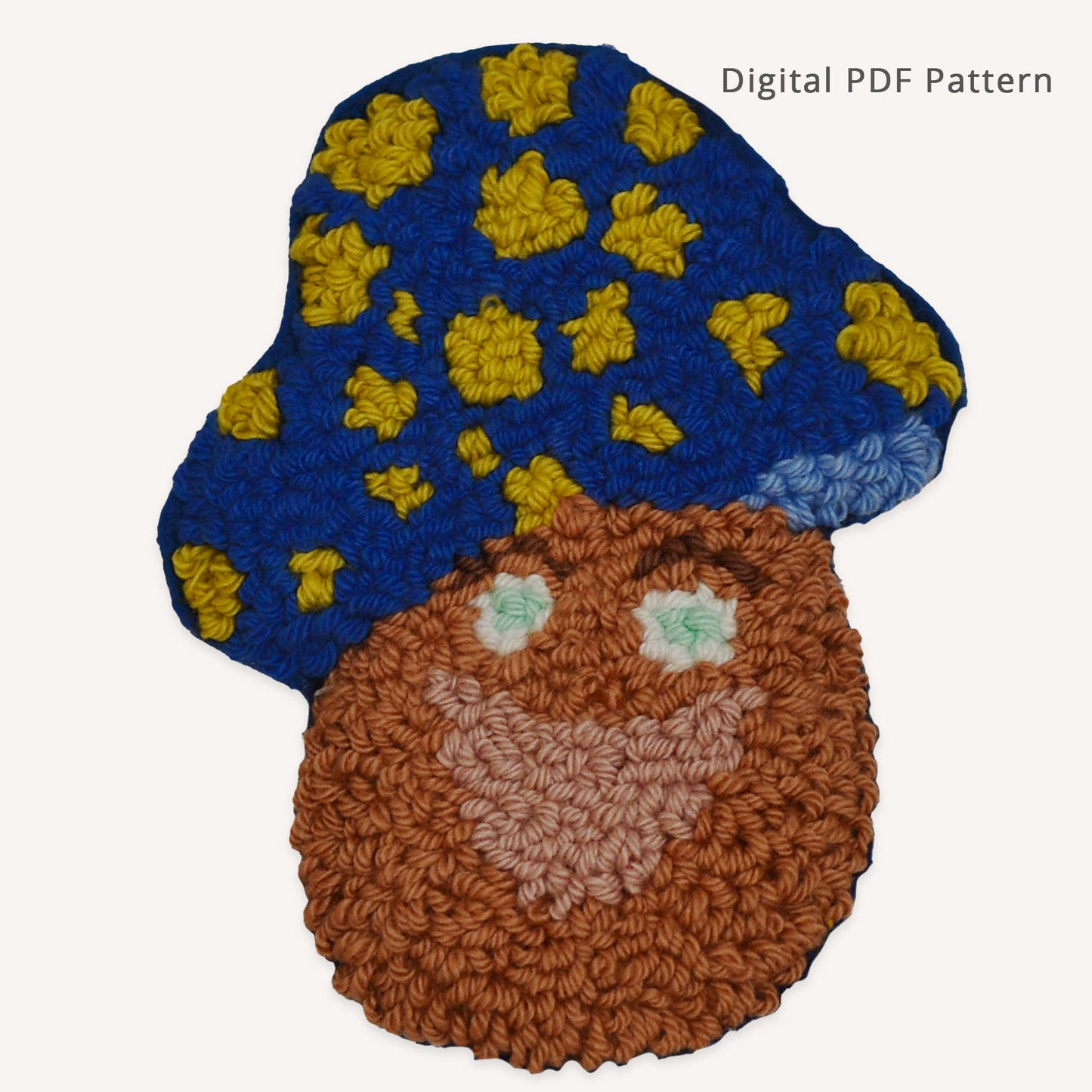Mushroom dad punch needle coaster pattern PDF featuring a smiling mushroom character with mint-green eyes, rosy pink lips, and a blue cap with yellow spots. Beginner-friendly digital pattern with printable template, color chart, and instant download.