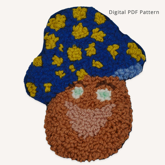 Mushroom dad punch needle coaster pattern PDF featuring a smiling mushroom character with mint-green eyes, rosy pink lips, and a blue cap with yellow spots. Beginner-friendly digital pattern with printable template, color chart, and instant download.