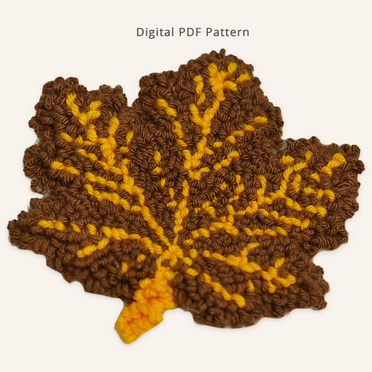Autumn maple leaf punch needle coaster pattern featuring warm brown loops and golden yellow veins. Textured fall leaf design shown as a digital PDF pattern for beginner-friendly punch needle crafting.